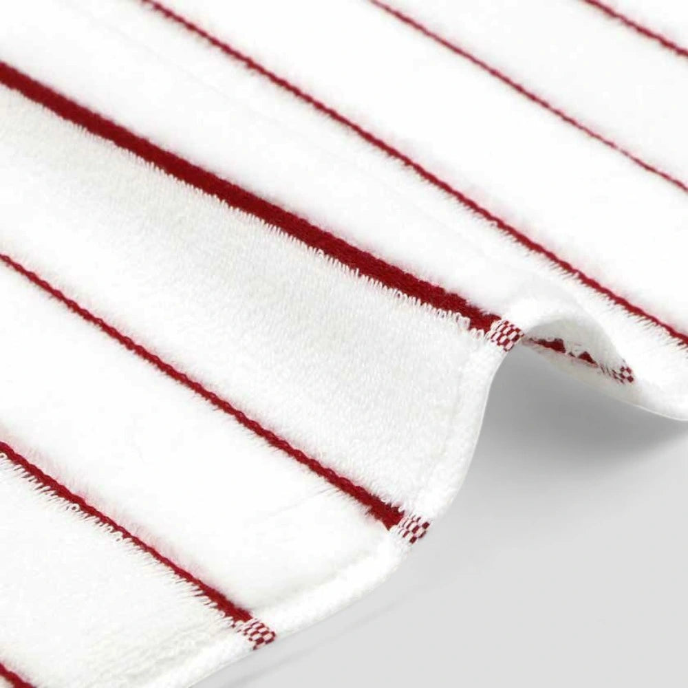 Close-up of the edge of white Imabari towel with red stripe.