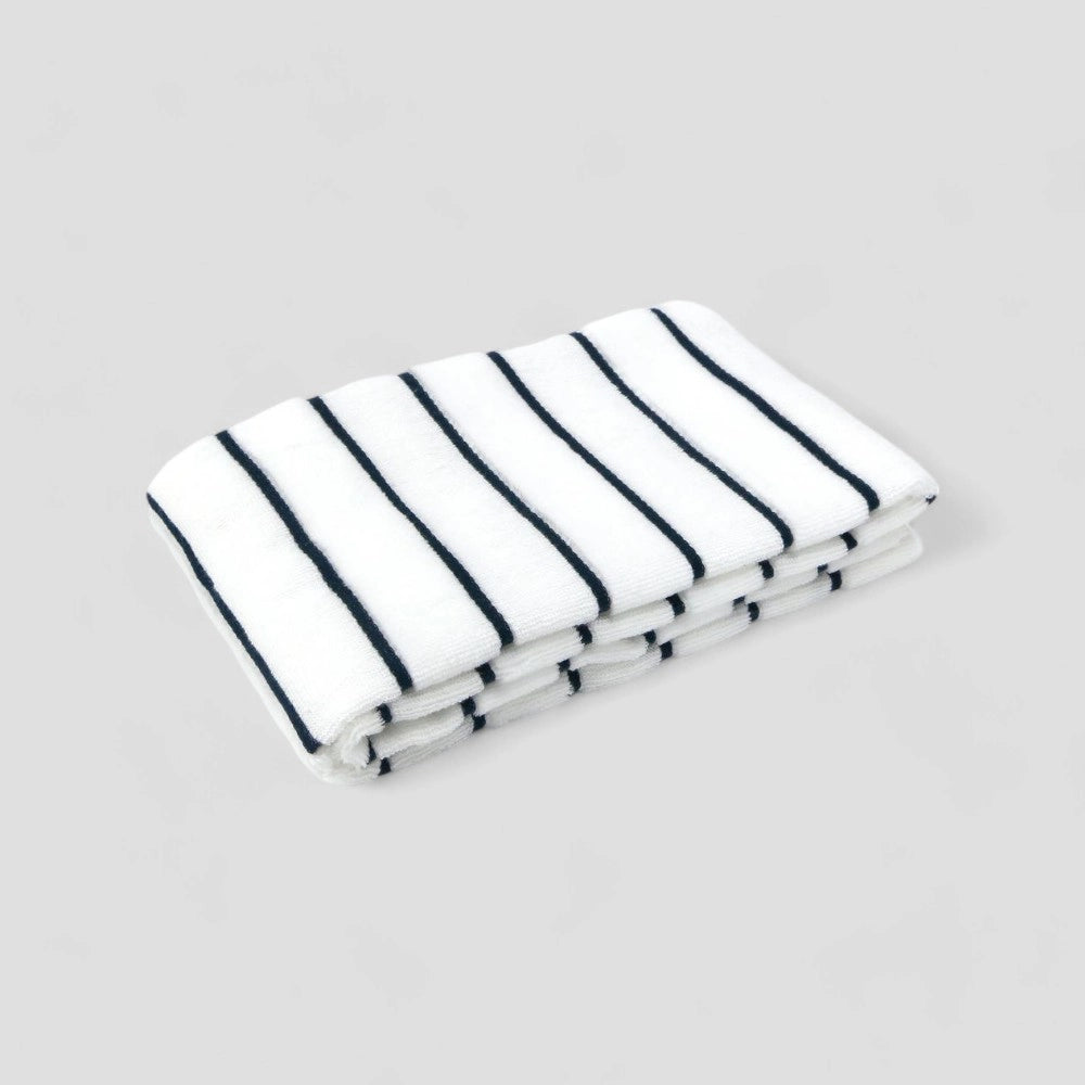 Folded white Imabari towel with navy stripe