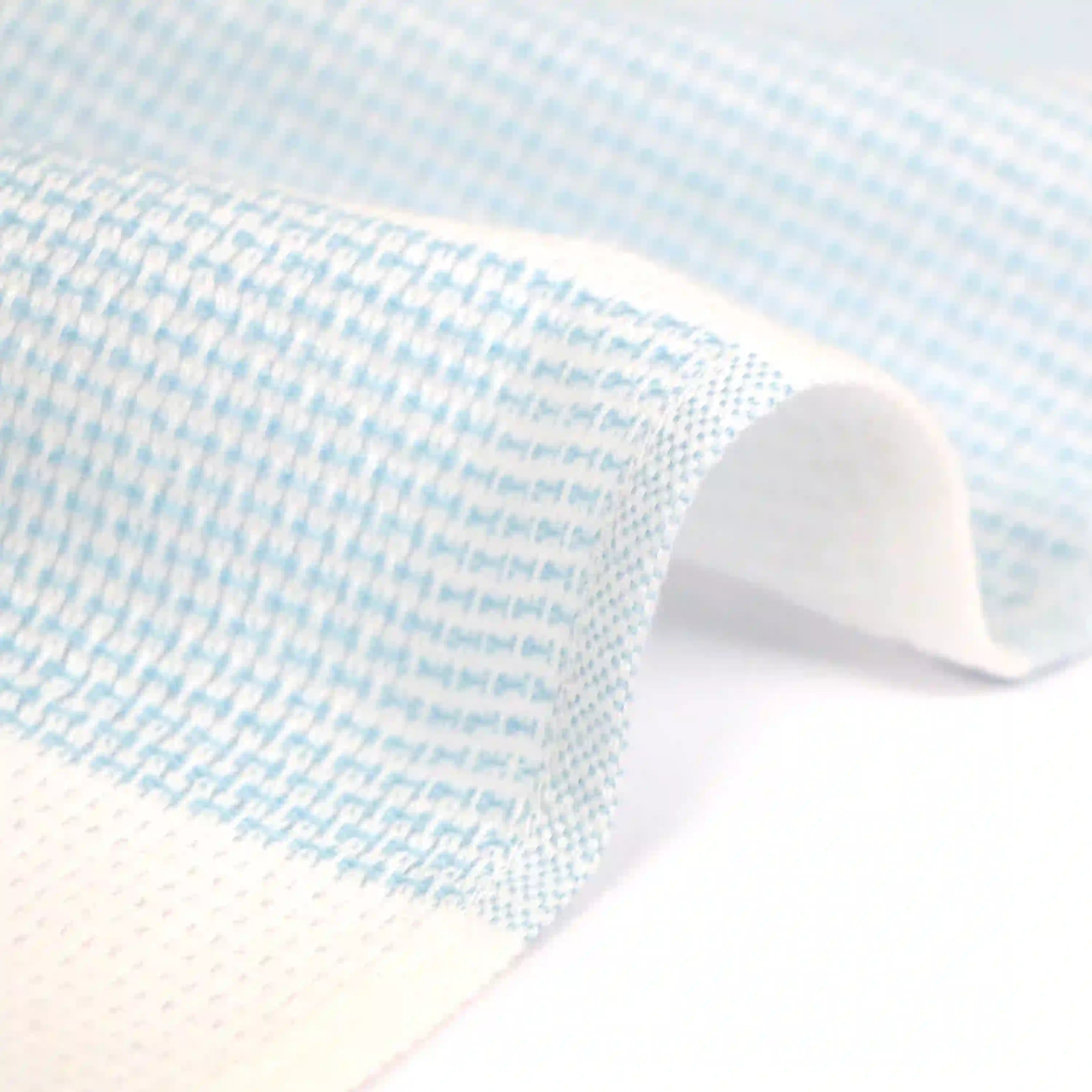 Close-up of a side of a Imabari towel wash cloth on blue pattern