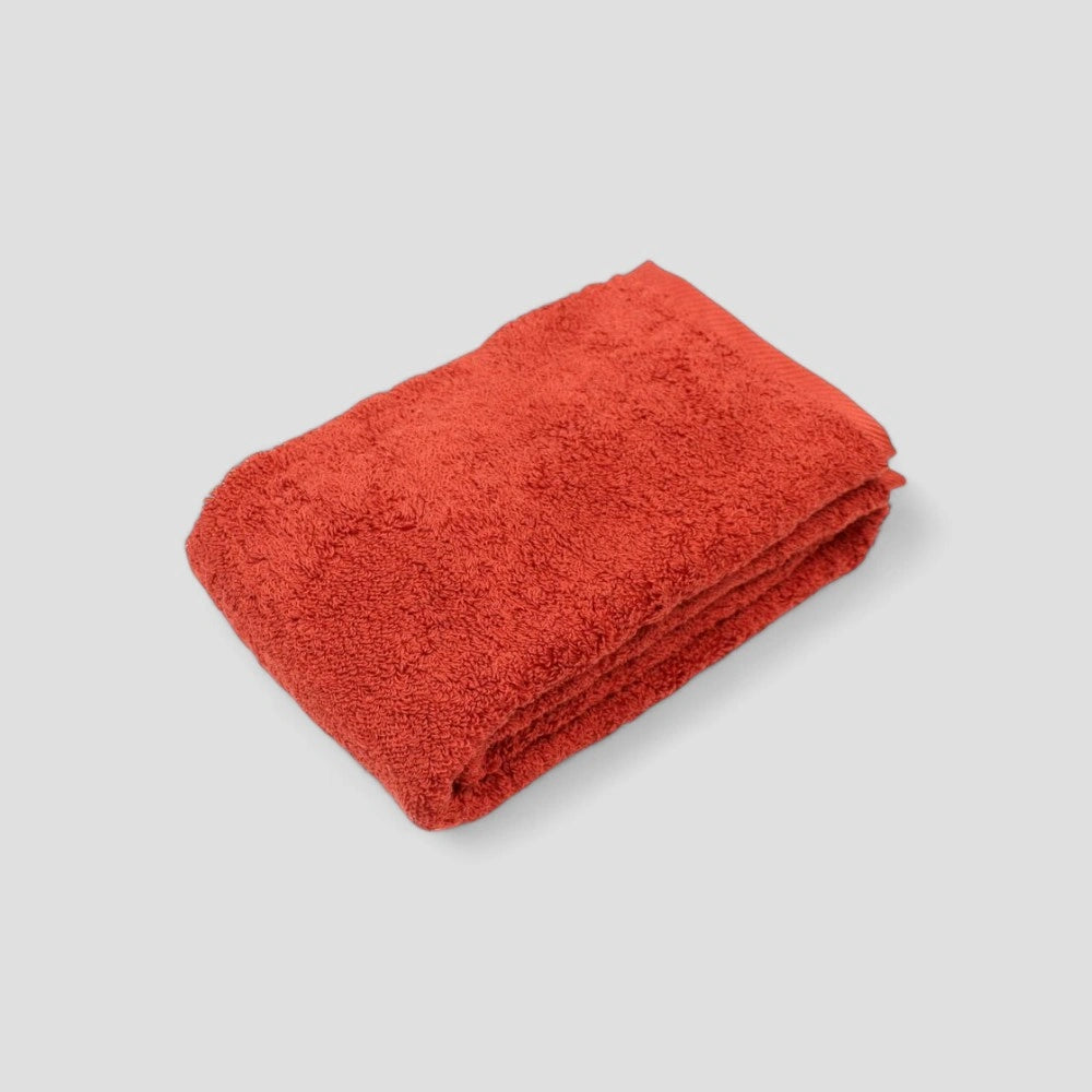 Folded red Imabari towel on the gray background