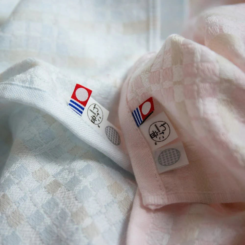 Close-up of labels of Iambari towel brand mark and Iori&