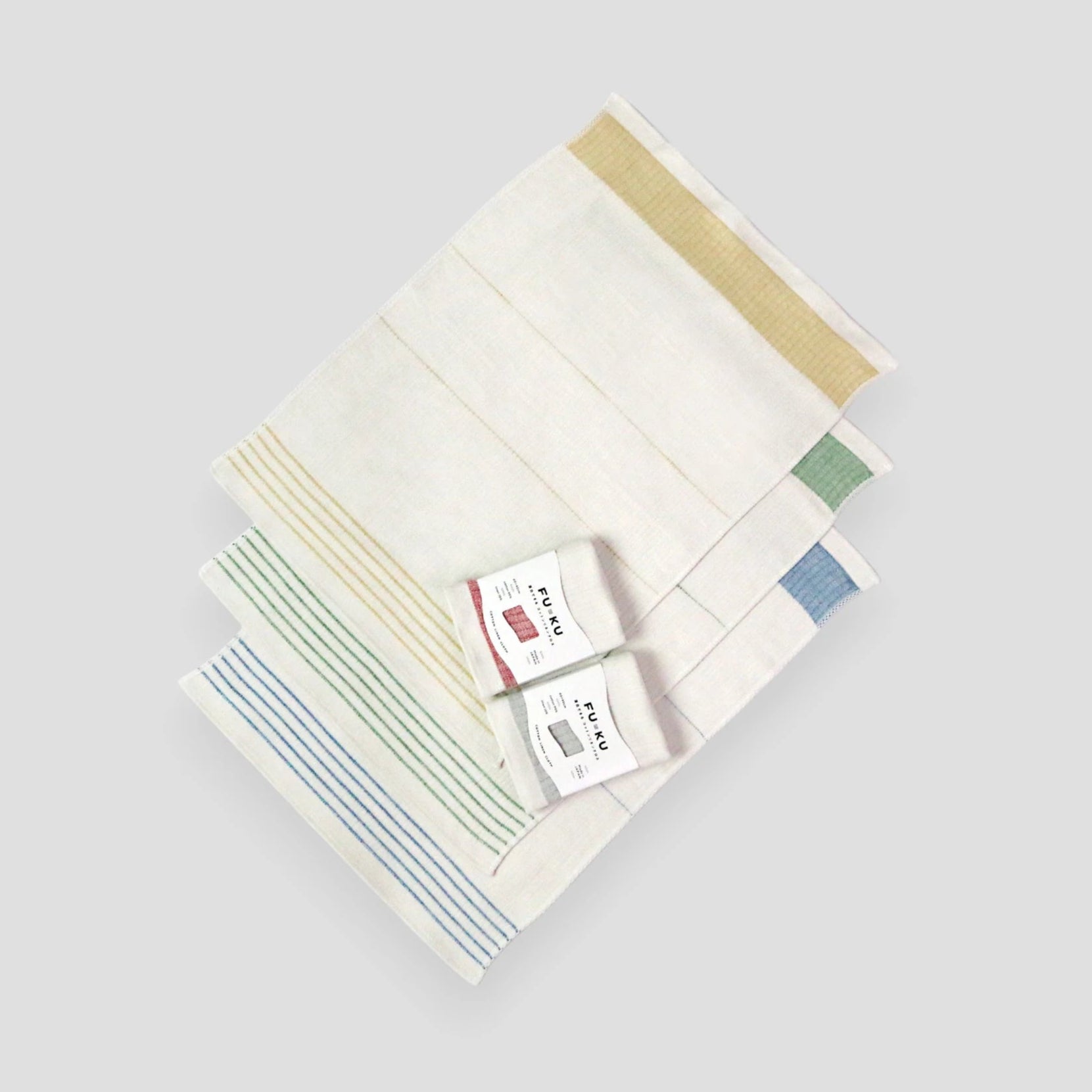 A set of folded multicolor Imabari towel linen kitchen cloths with a label on top, displayed on a white background.