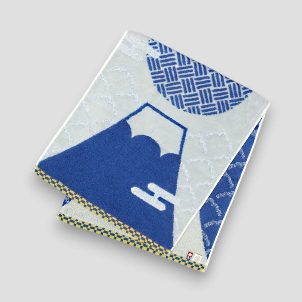 Folded Imabari towel featuring geometric and Mt. fuji patterns, with blue colors prominently displayed, on a white background.