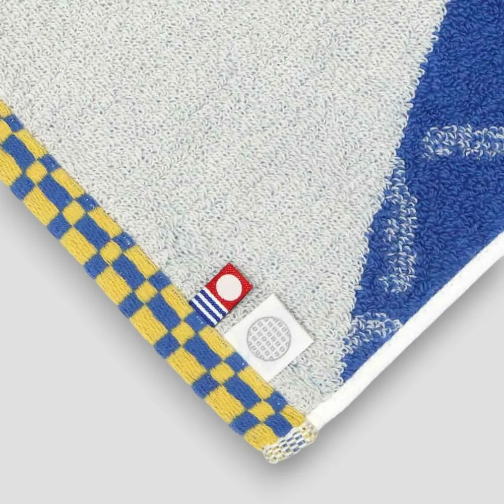 Close-up of labels Imabri towel with blue pattern Imabari towel brand mark and IORI&