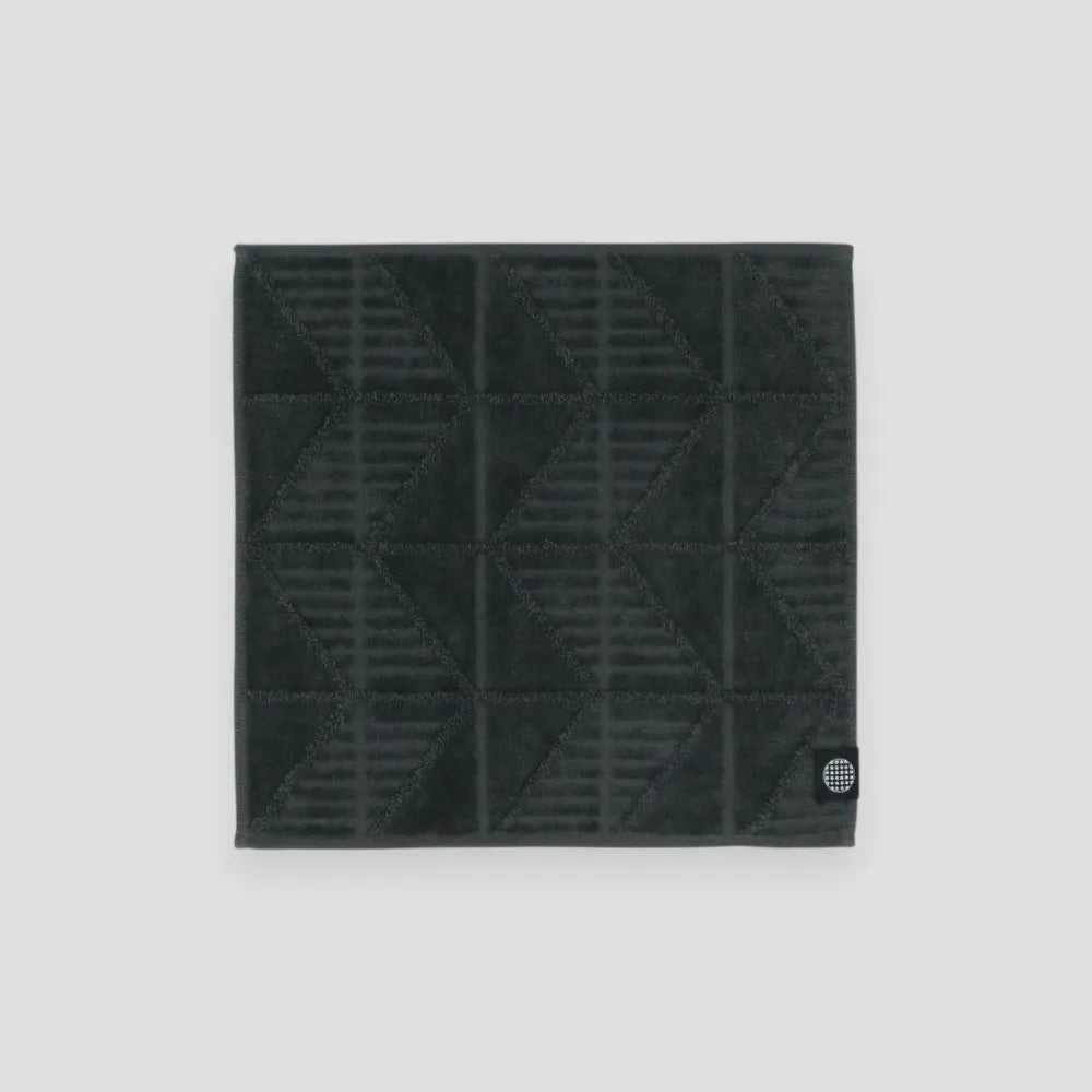 Charcoal Imabari towel with herringbone pattern on a light gray background