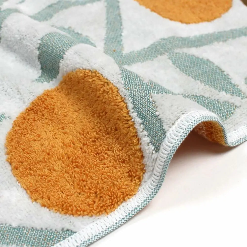 Close-up of a side of Imabari towel with orange and leaf pattern