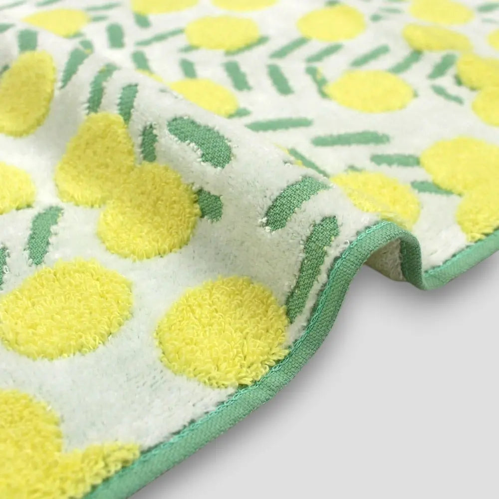 Close-up of a side Iambari towel with yellow floral patttern