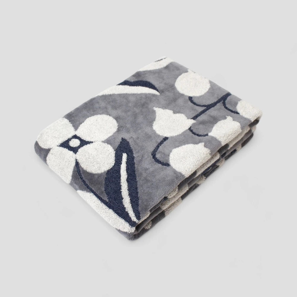 Folded dark gray Imabari towels with a jacquard floral pattern