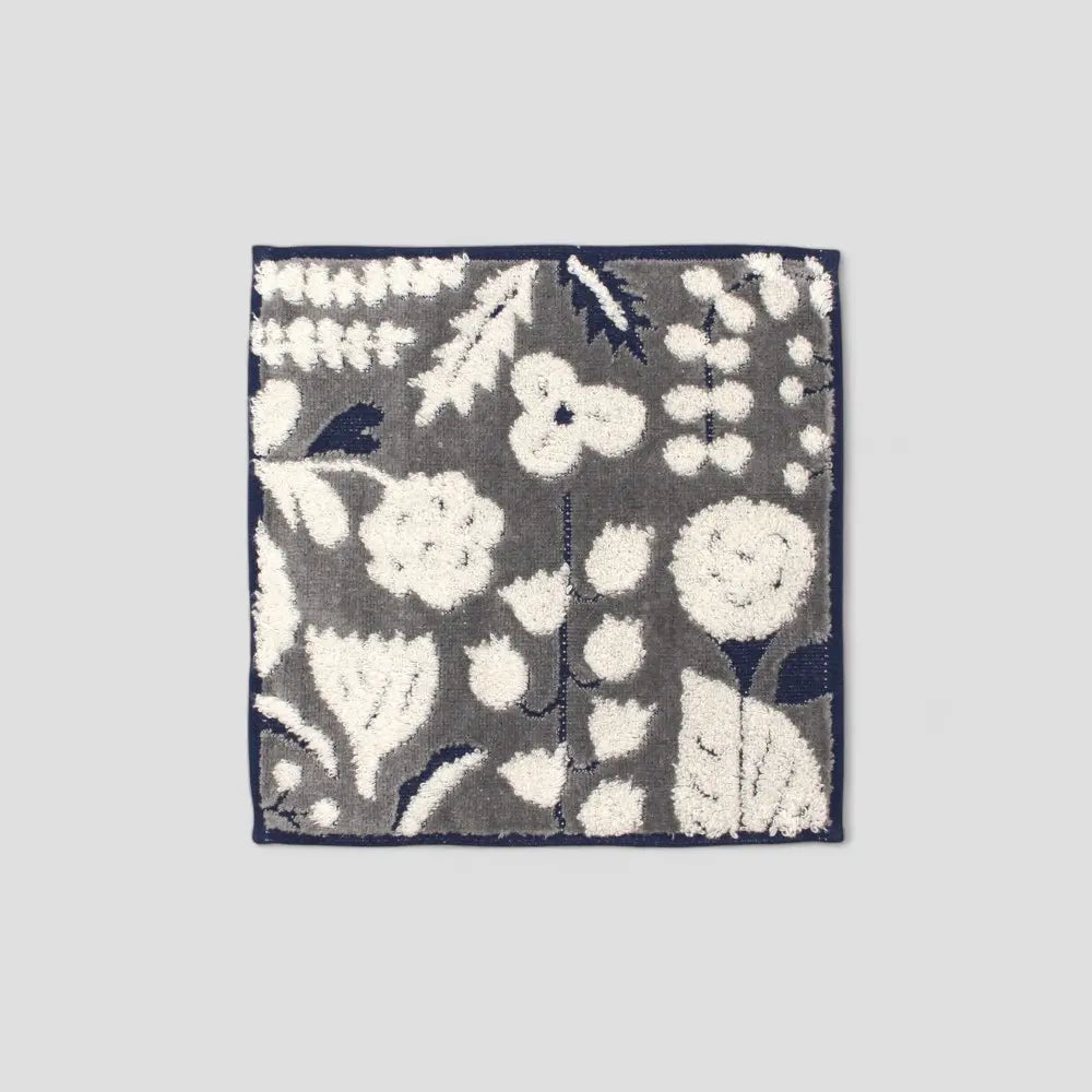 A dark gray square Imabari owels with a floral jacquard pattern