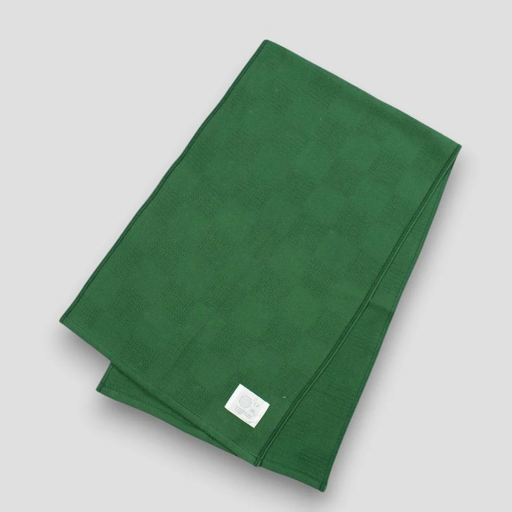 Green "Non-Pile" Imabari towel with a brand label on a light gray background