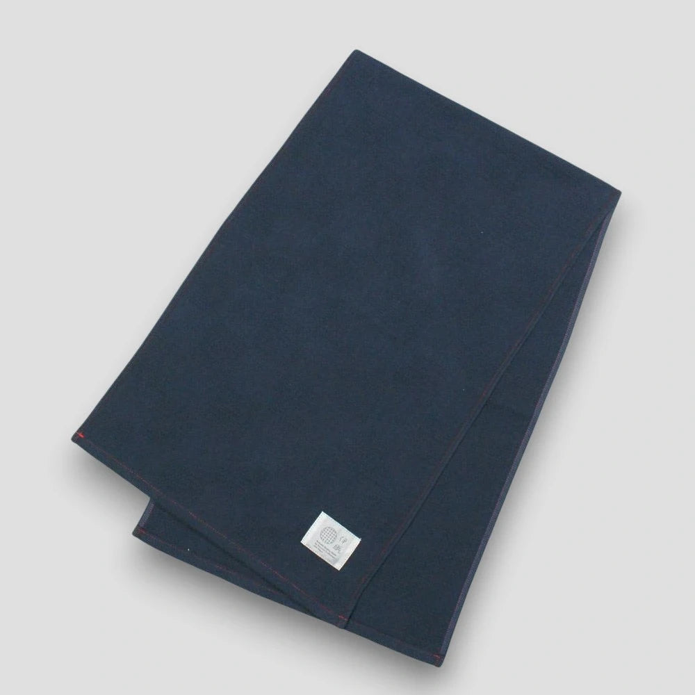 Navy "Non-Pile" Imabari towel with a brand label on a light gray background