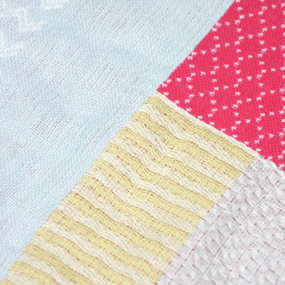 Close-up of the Texture of patchwork design Imabari towel fabric in red and yellow colors
