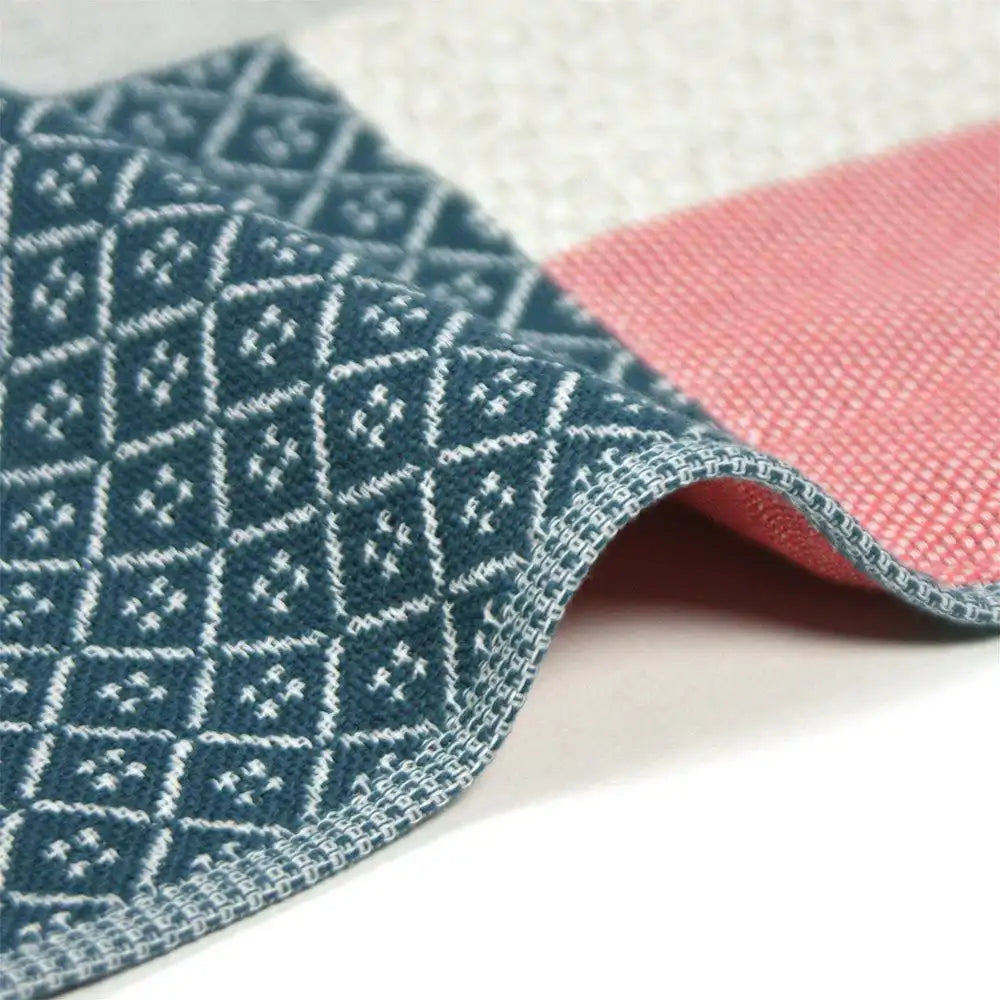 Close-up of a side of patchwork design Imabari towel in navy and red colors