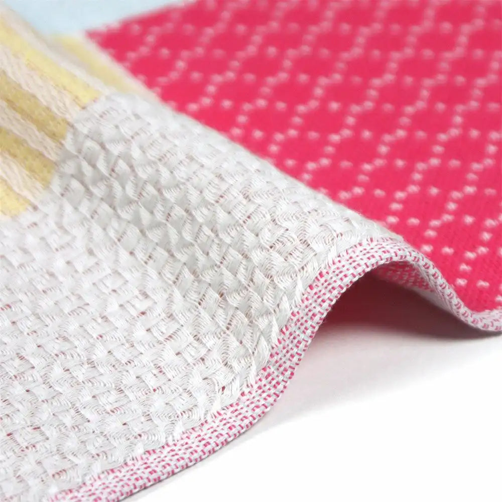 Close-up of a side of patchwork design Imabari towel pink and white colors