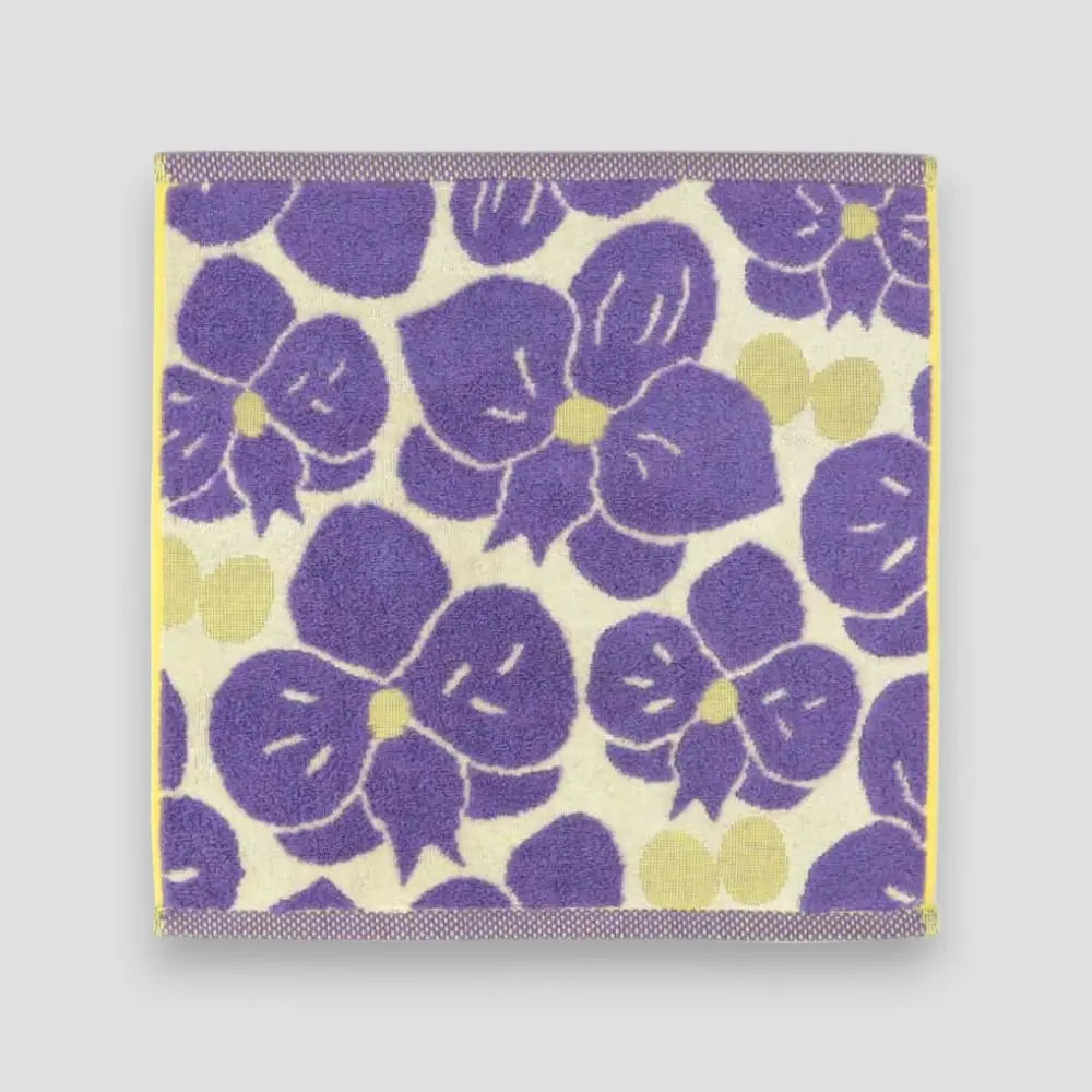 A purple floral Imabari towel on the light gray background