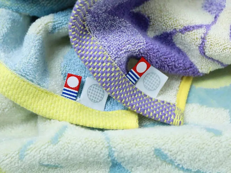 Close-up of Imabari towel with labels of Imabari towel brand mark and IORI&