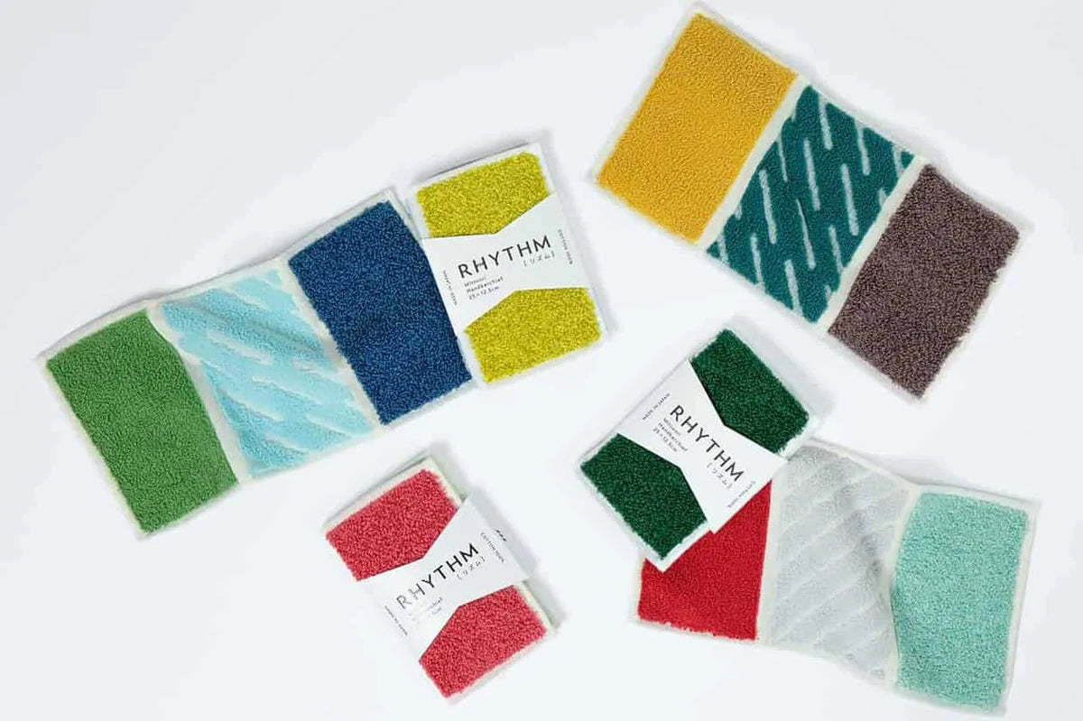 A collection of colorful RHYTHM series tri-fold pocket mini Imabari towels displayed on a white background.