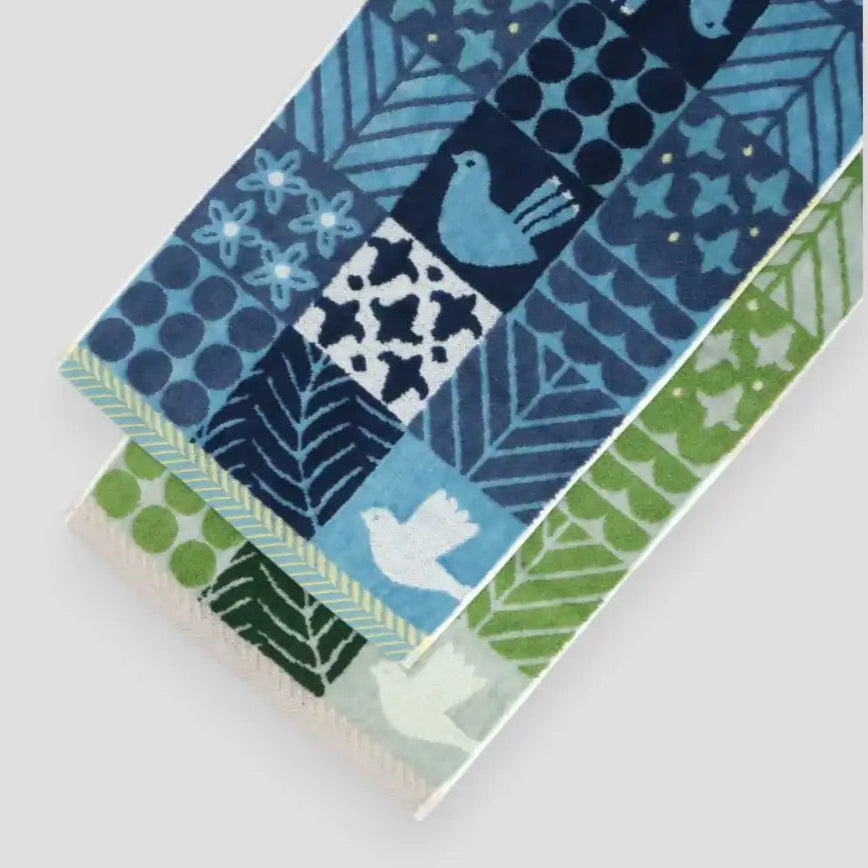 A blue and green birds and floral patterned Imabari towels displayed
