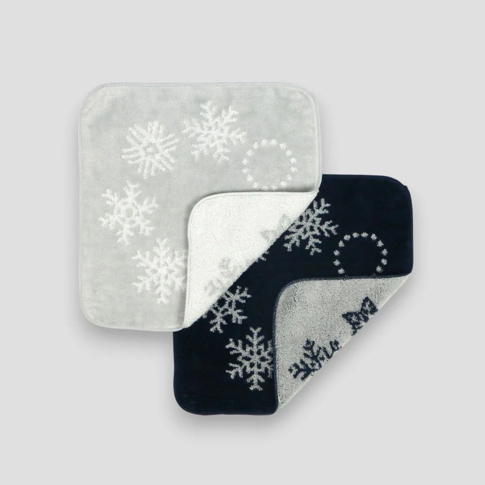 Two square Imabari towels with snowflake design on a light gray background