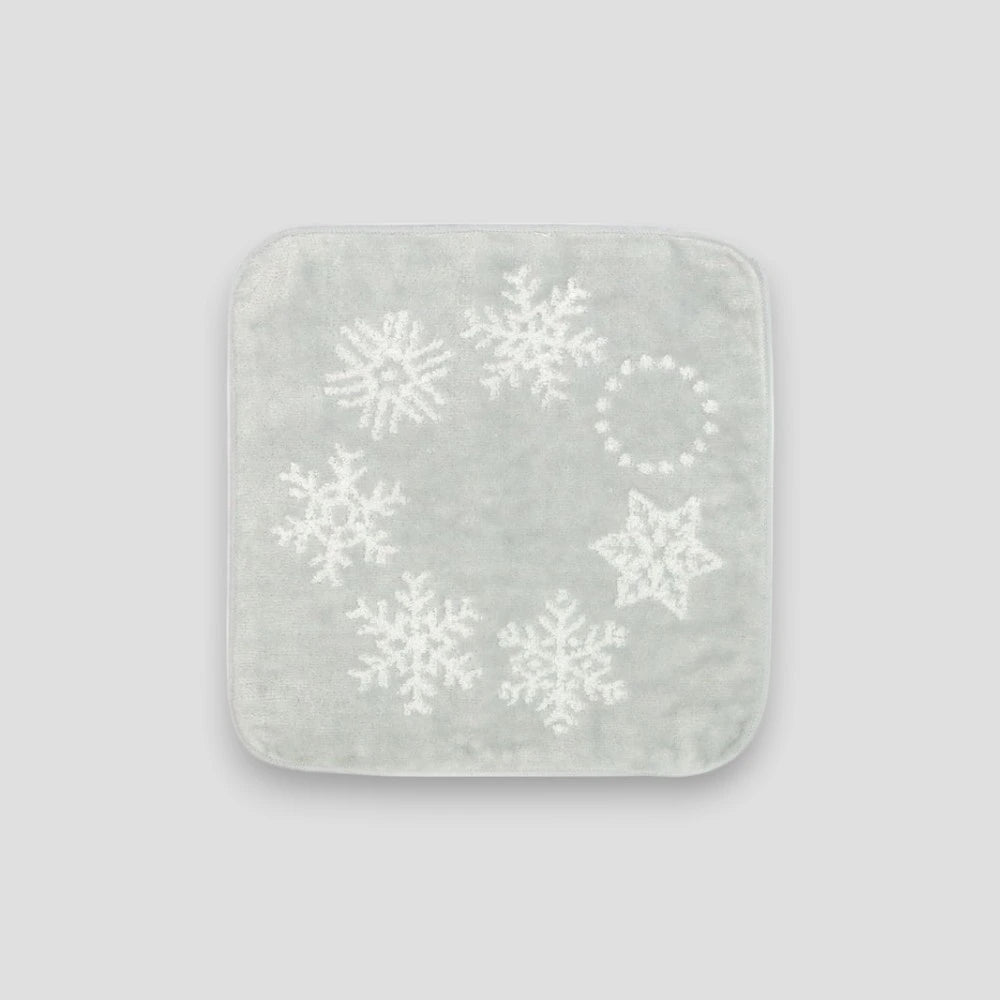Gray square Imabari towel with white snowflake patterns on a light gray background