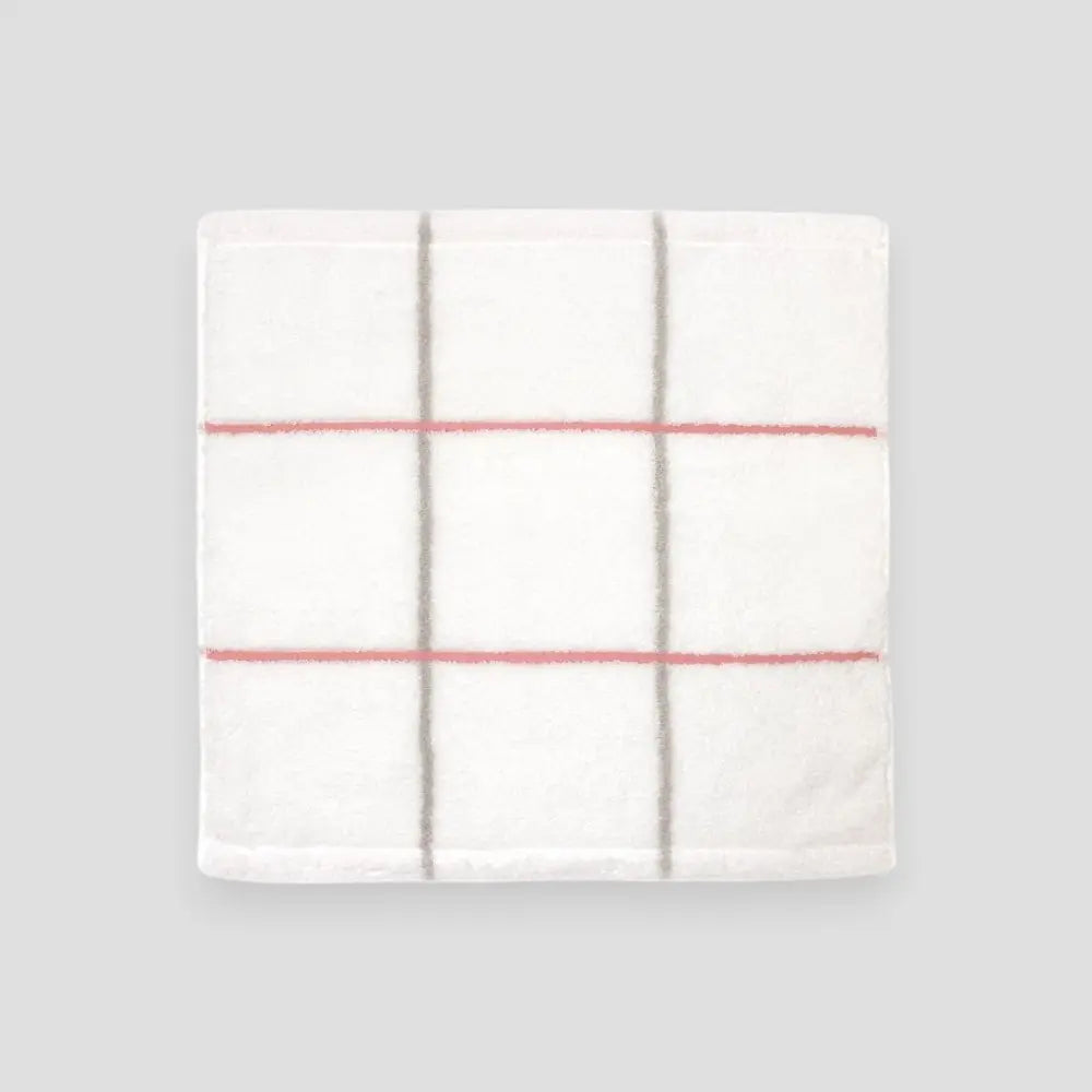 Square white Imabari towel with pink stripe on gray background