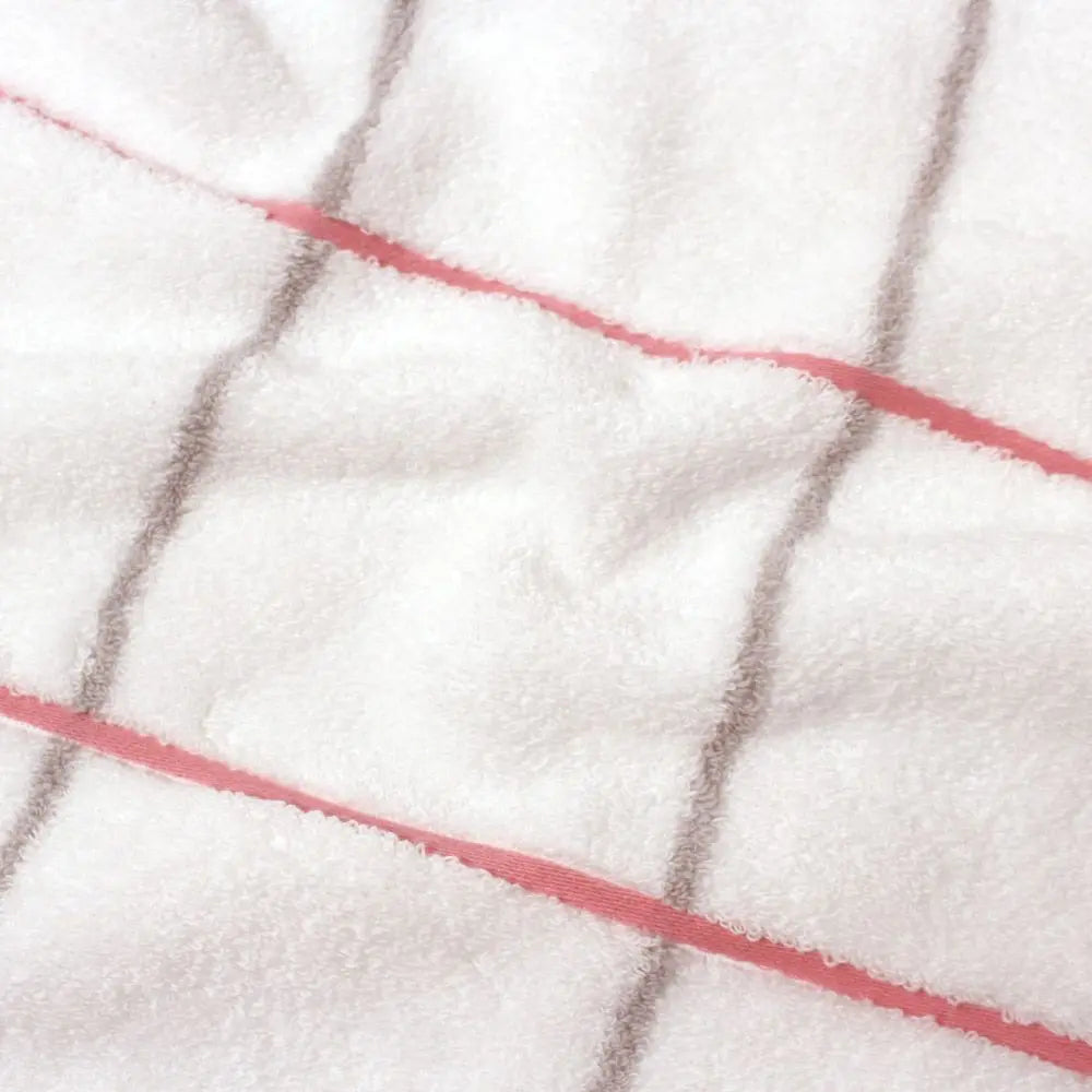 Close-up of cotton fabric of white Imabari towel with pink and gray line