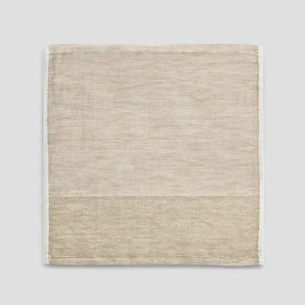 Beige Imabari towel with a subtle herringbone pattern on a light gray background.
