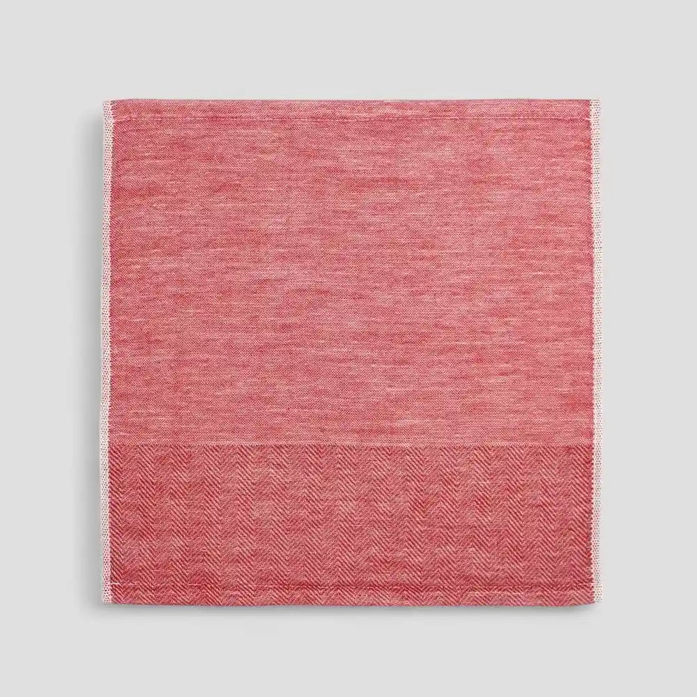 Red Imabari towel with a subtle herringbone pattern on a light gray background.