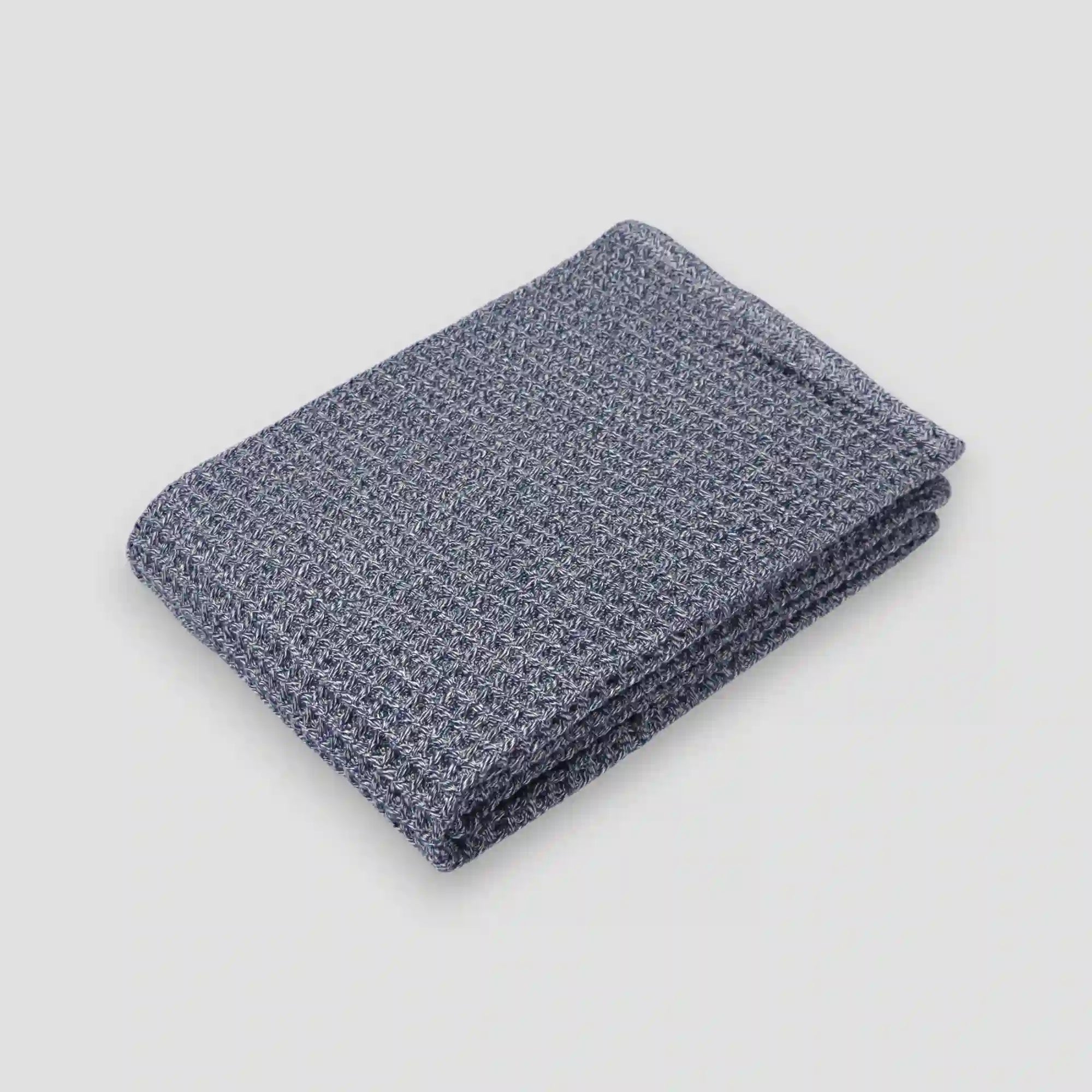 Navy blue waffle Imabari towel on a gray background