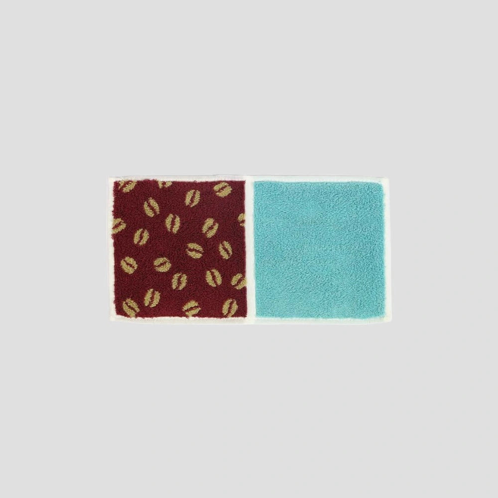 A compact Imabari towel in brown coffee beans patterns, displayed against a white background.