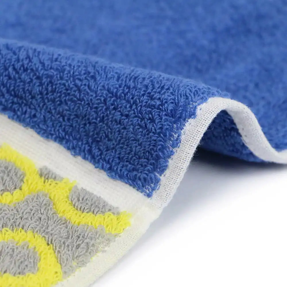 Close up of a side of a compact Imabari towel in vibrant patterns