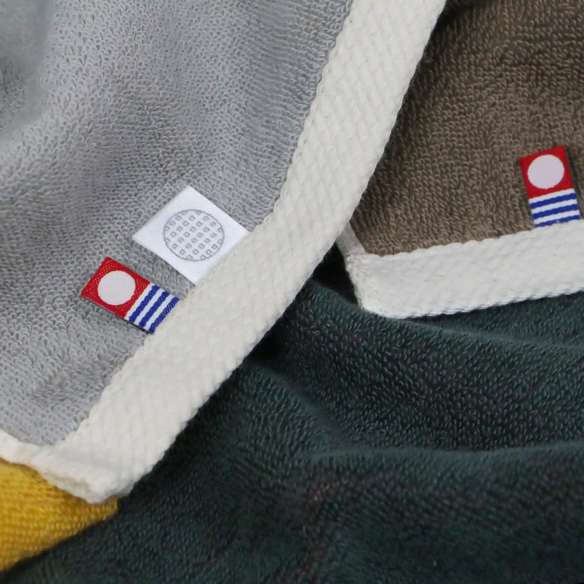 A close-up of a reversible Imabari towel with brand labels