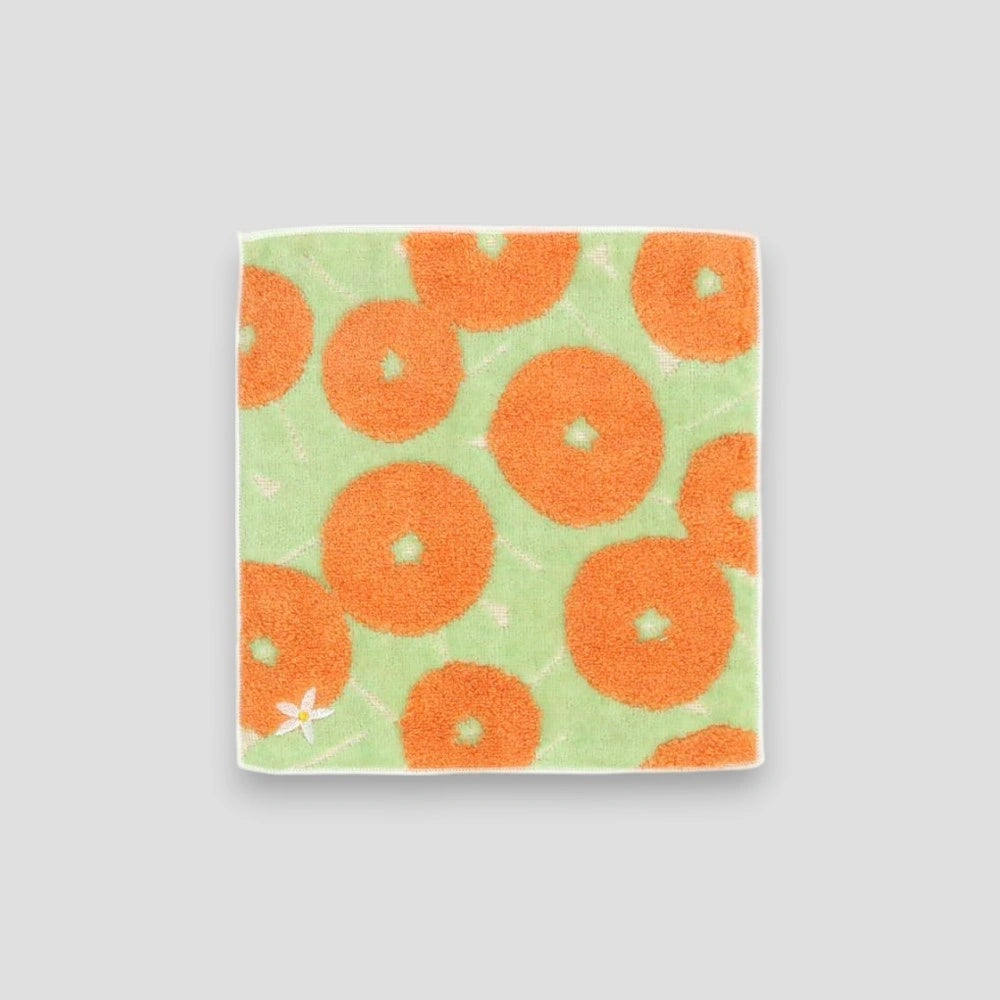 A small square orange Iyokan patterned Imabari towel with a small white flower