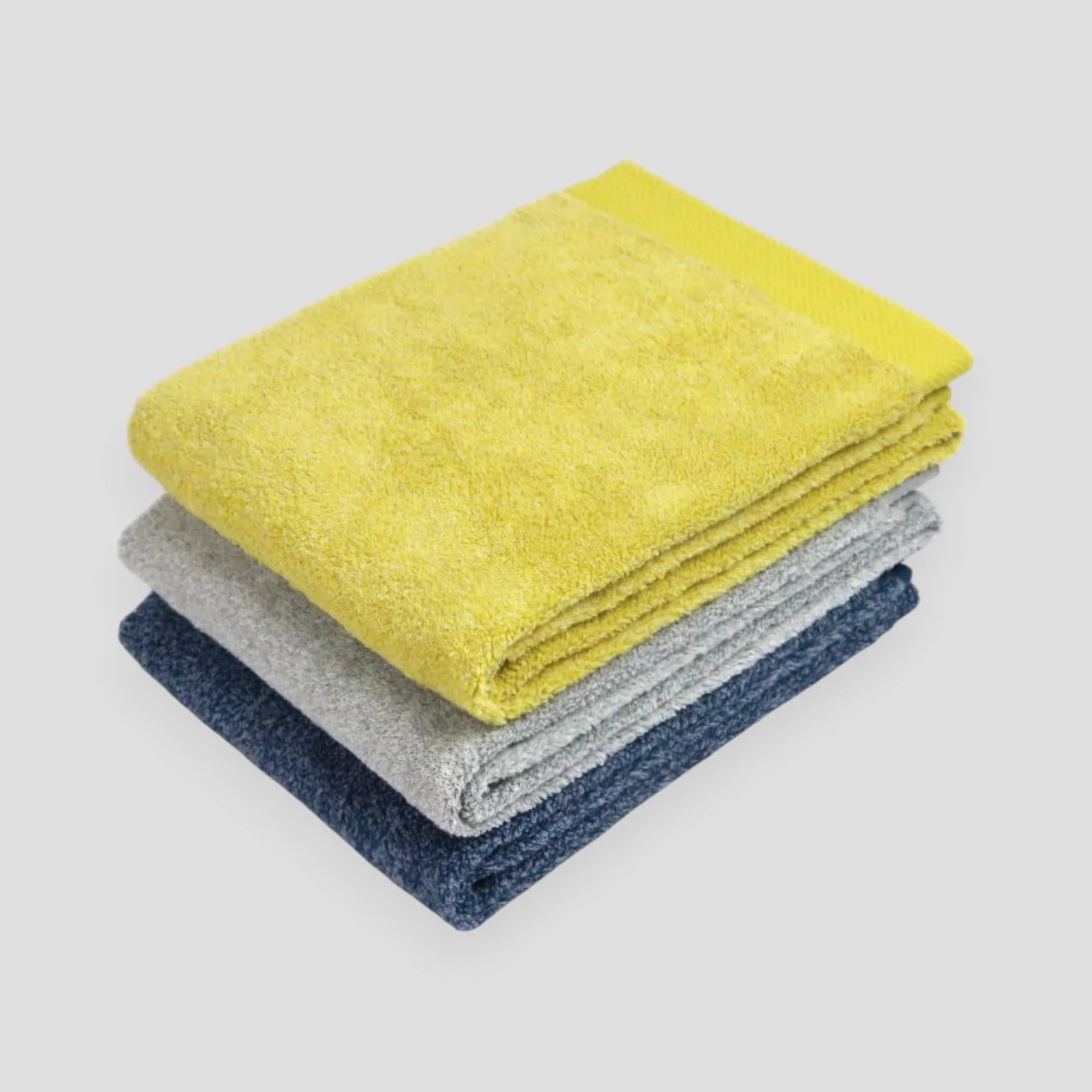 Folded colorful Imabari towel with light gray background.
