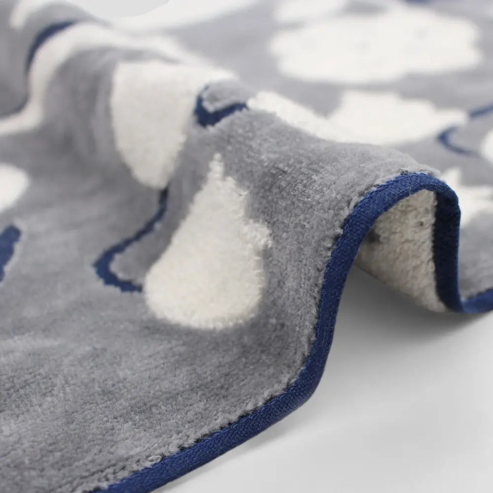 Close up of a side of dark gray Imabari towel with a jacquard floral pattern