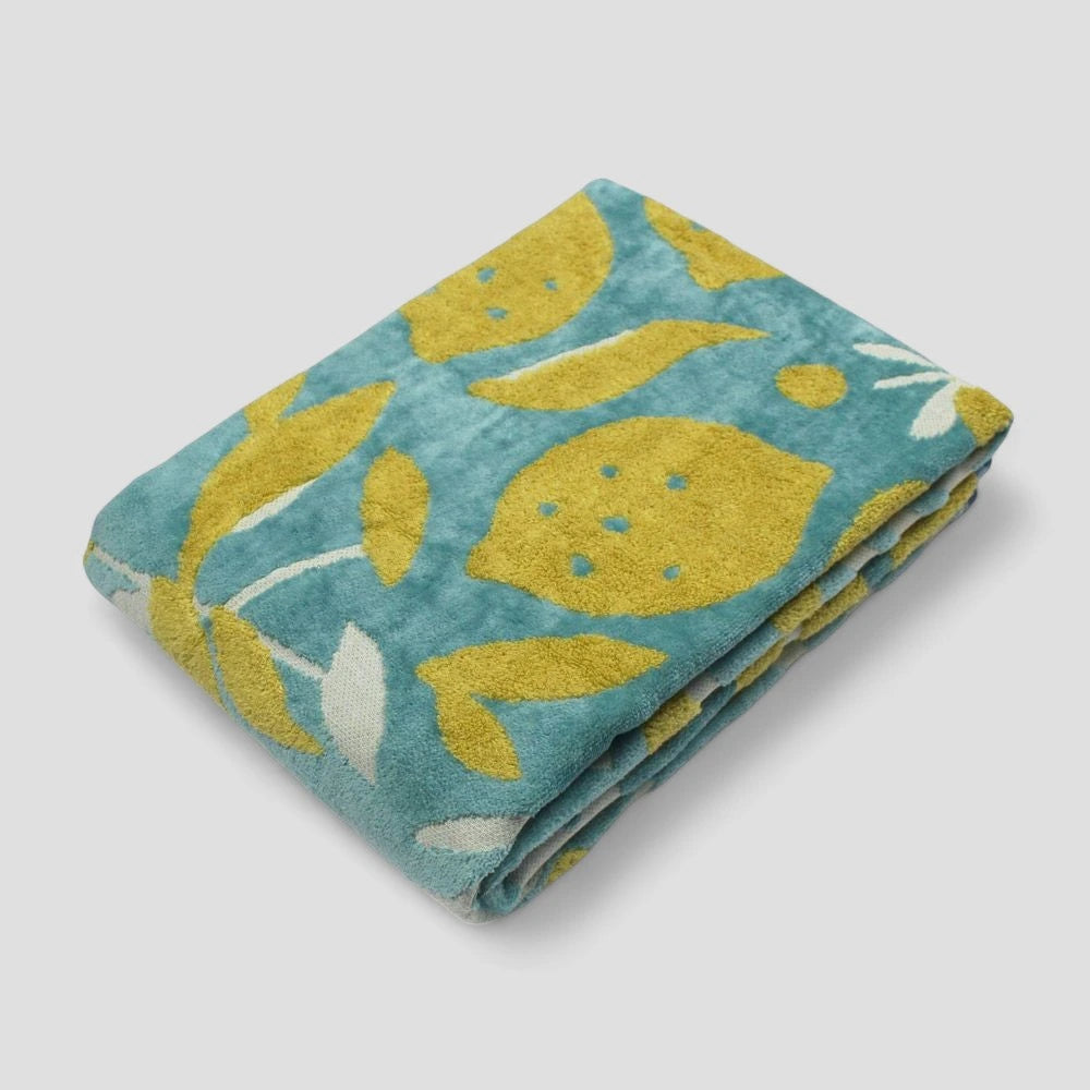 A folded Imabari towel with Lemon patterns, blue tones, made from 100% cotton.