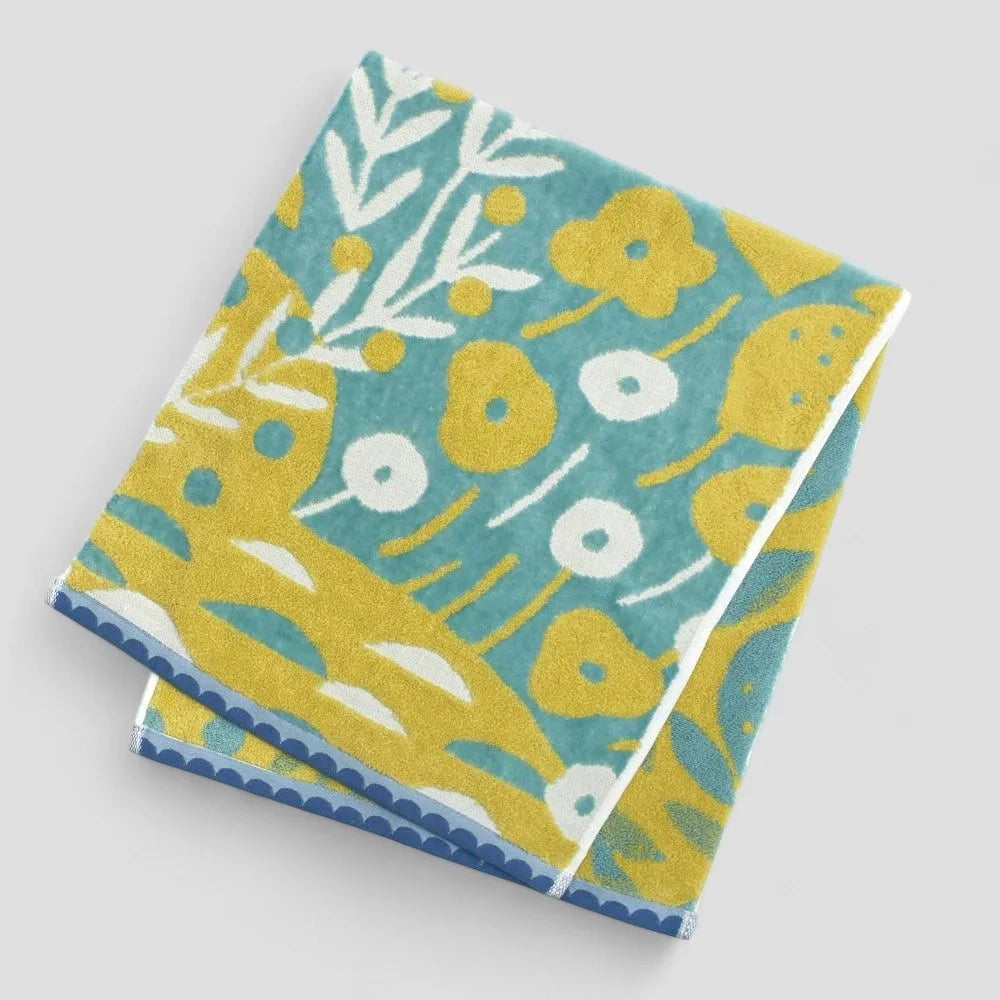 A folded Imabari towel with multicolored patterns, including blue tone made from 100% cotton.