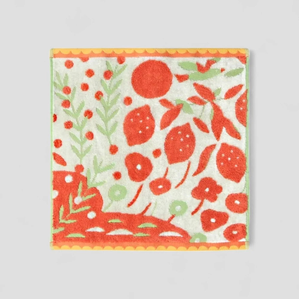 Imabari towel with multicolored patterns, including orange tones, made from 100% cotton.