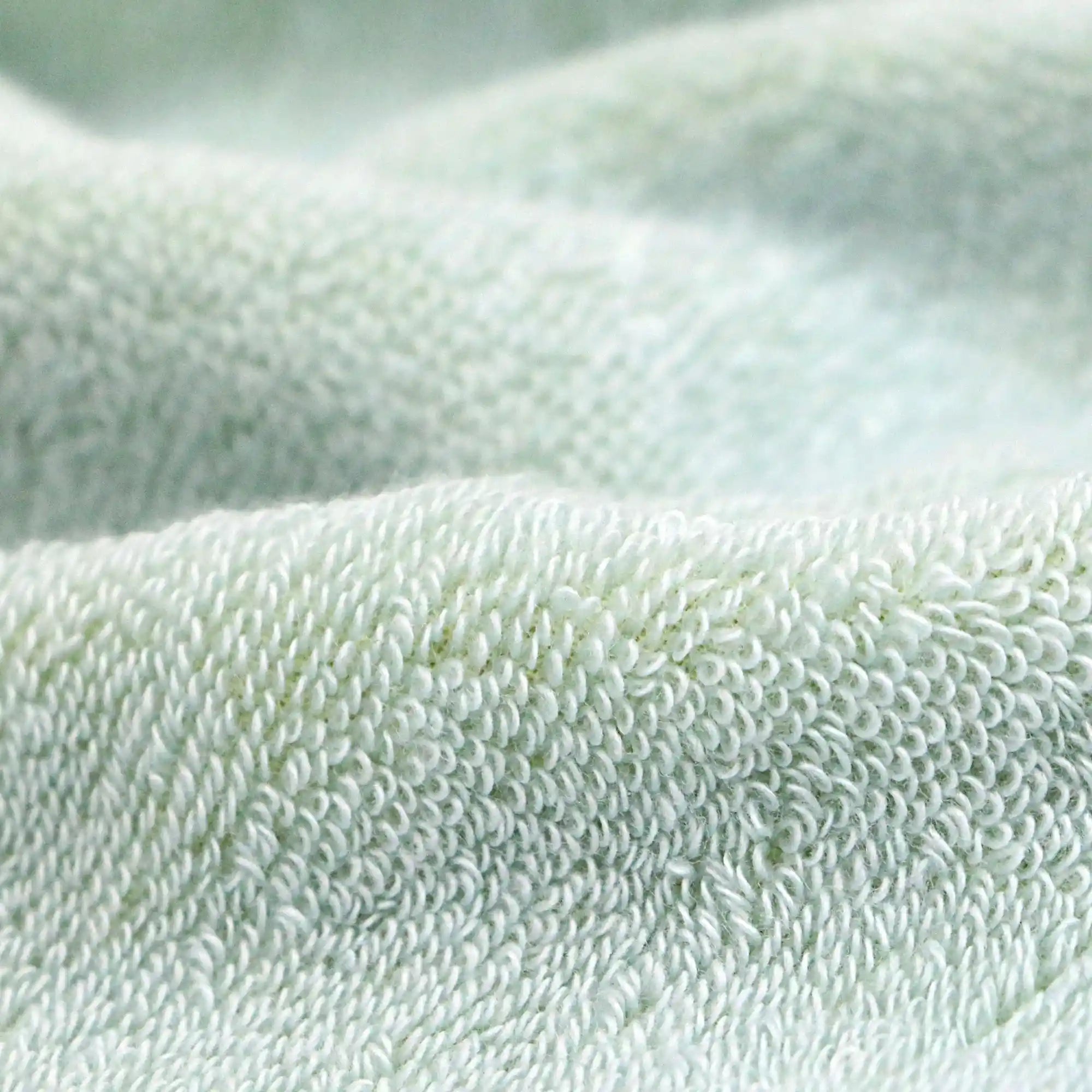 A close-up of the texture of a blue pile-weave Imabari towel for sports.