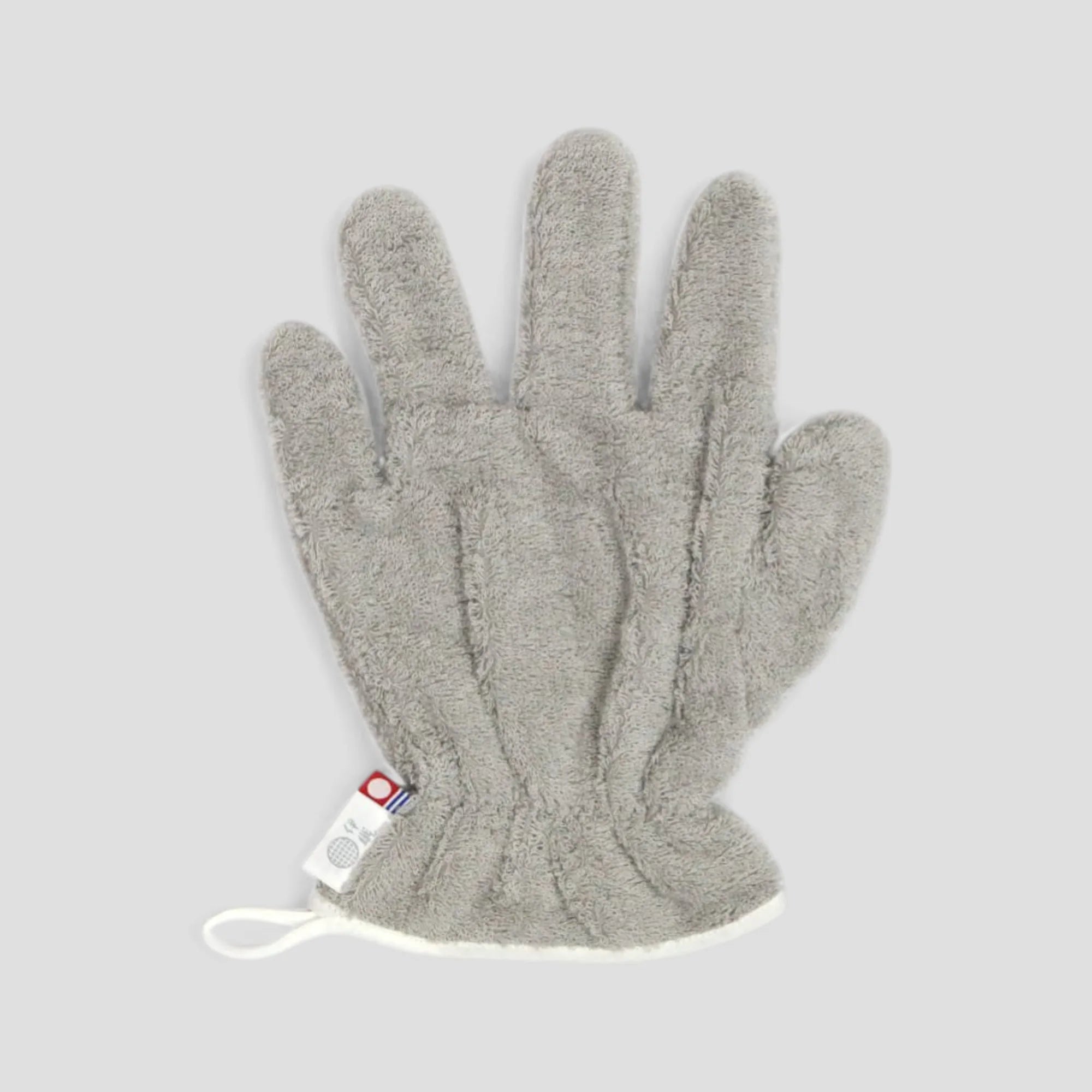 Gray Imabari towel hair-dry-glove with a brand label on a light gray background