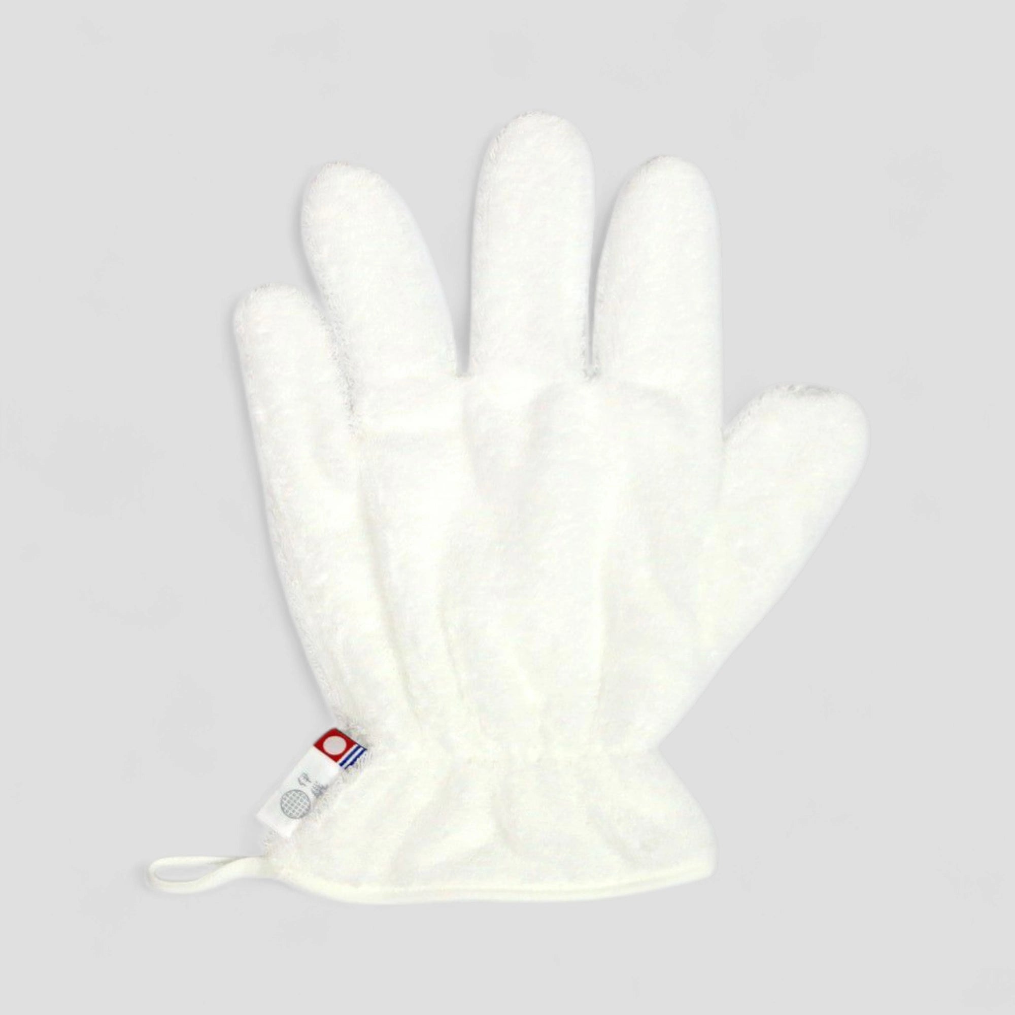 White Imabari towel hair-dry-glove with a brand label on a light gray background