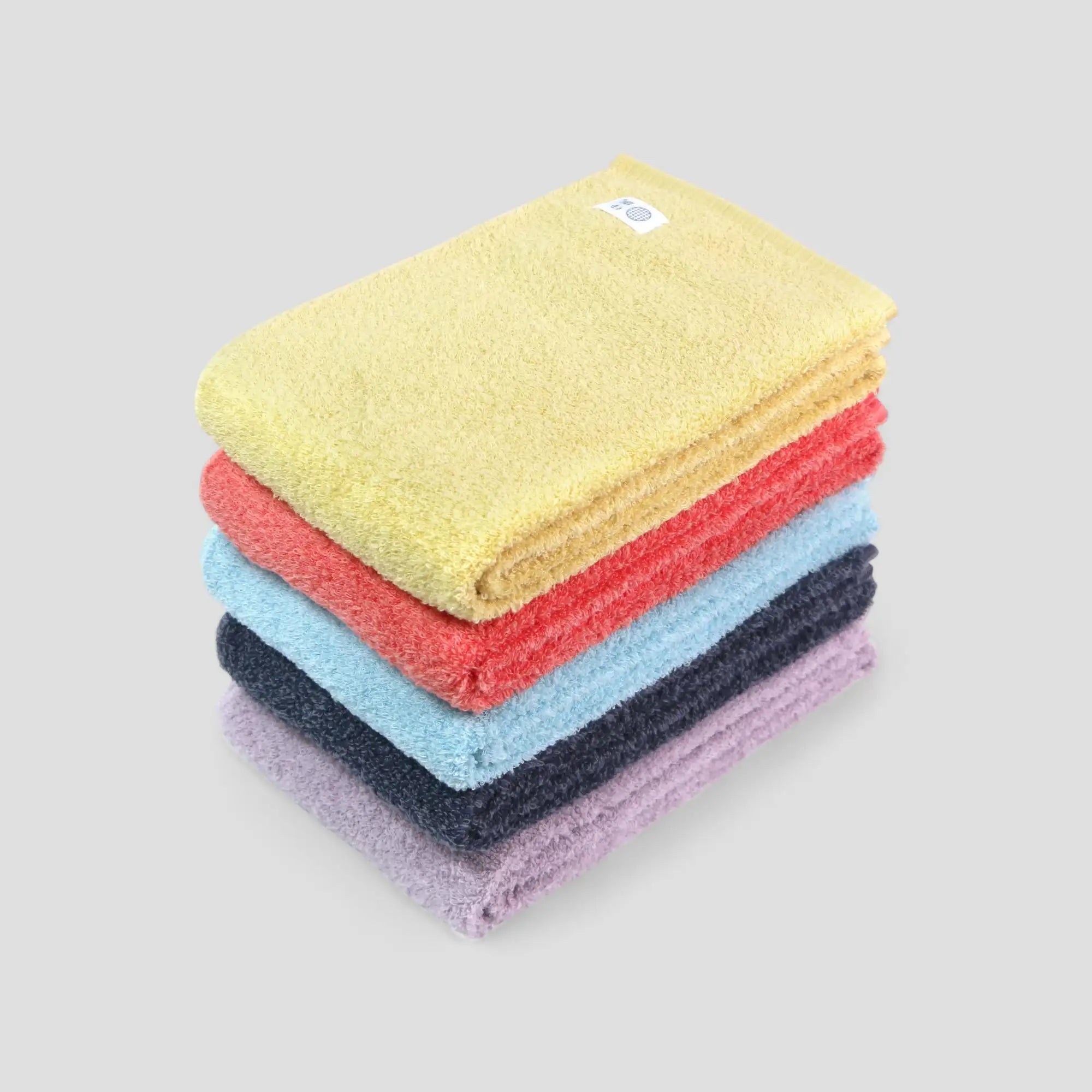 Stack of colorful Imabari towel on a light gray background