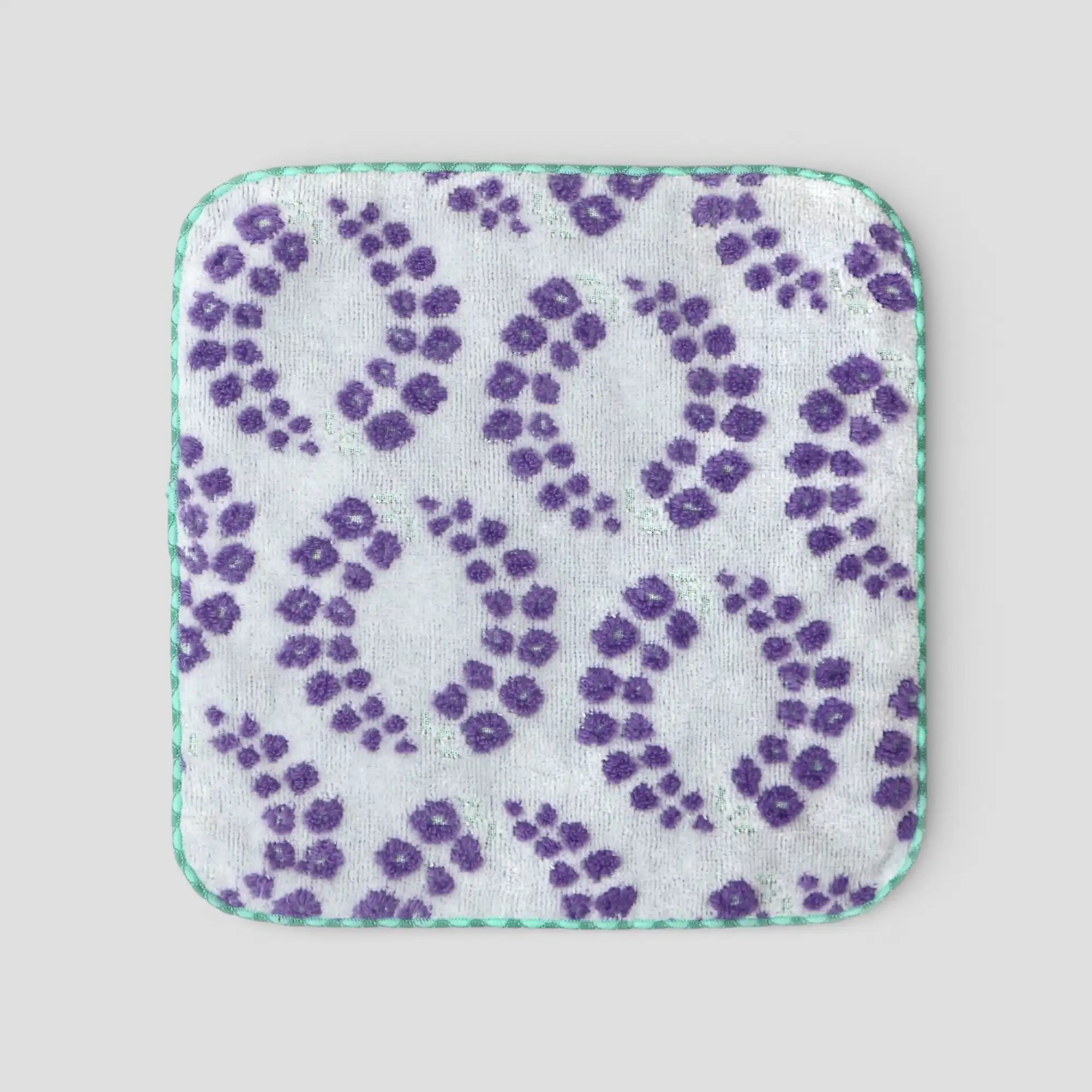 Imabari towel square with purple floral pattern on a light gray background