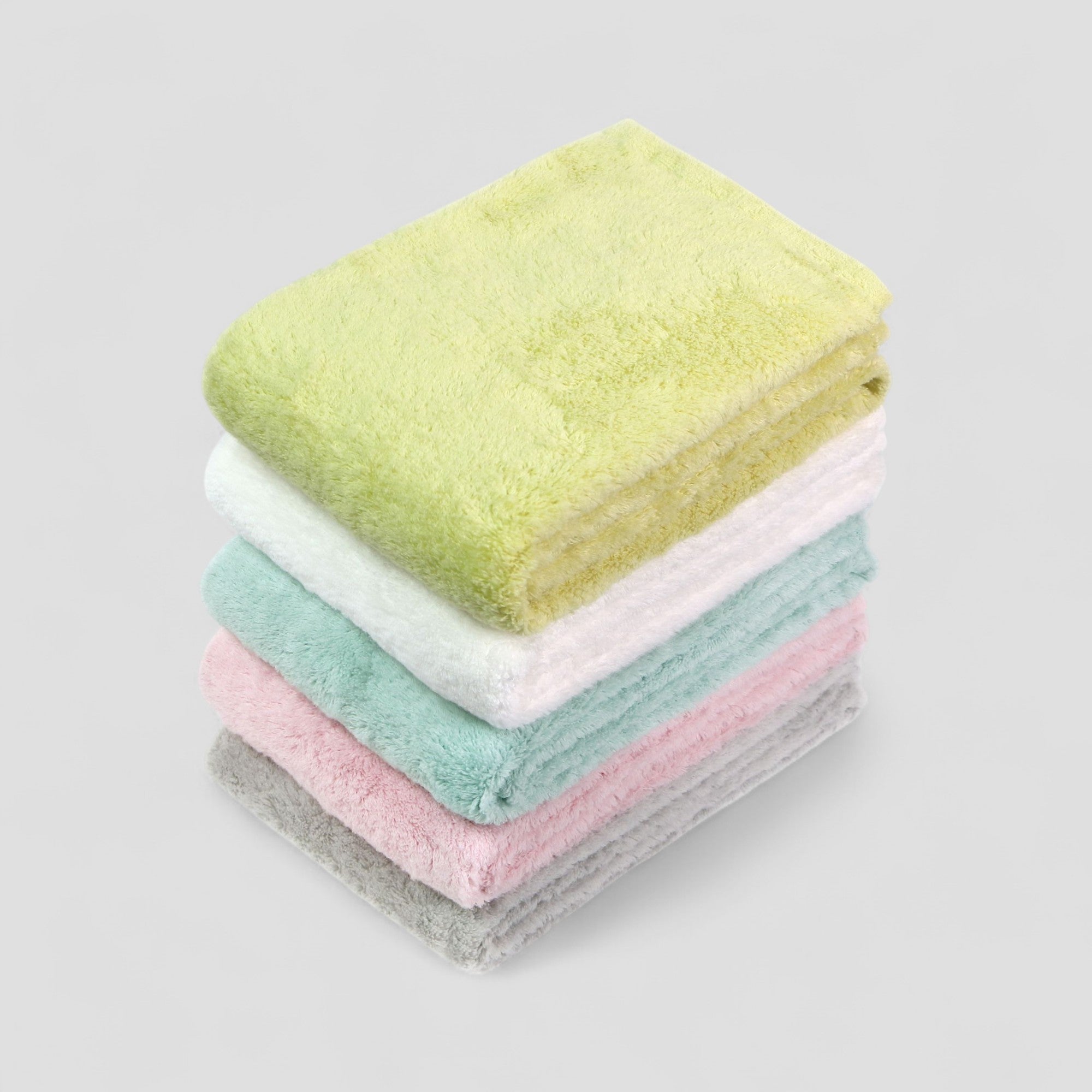 Stack of colorful Imabari towels on a light gray background