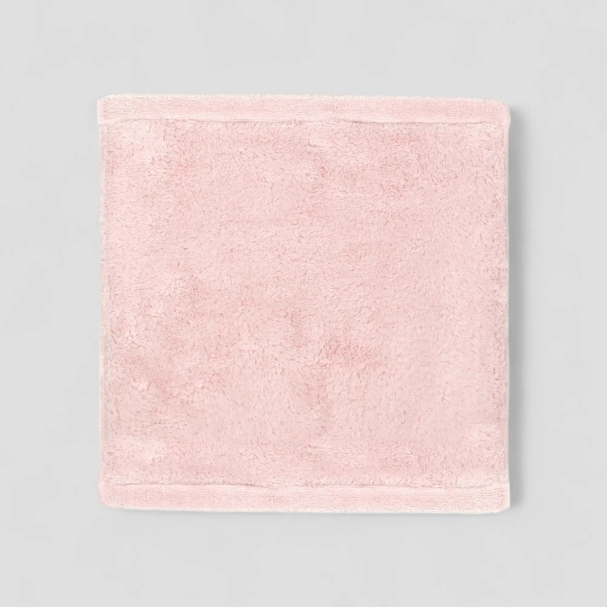 Pink Imabari towel on a gray background