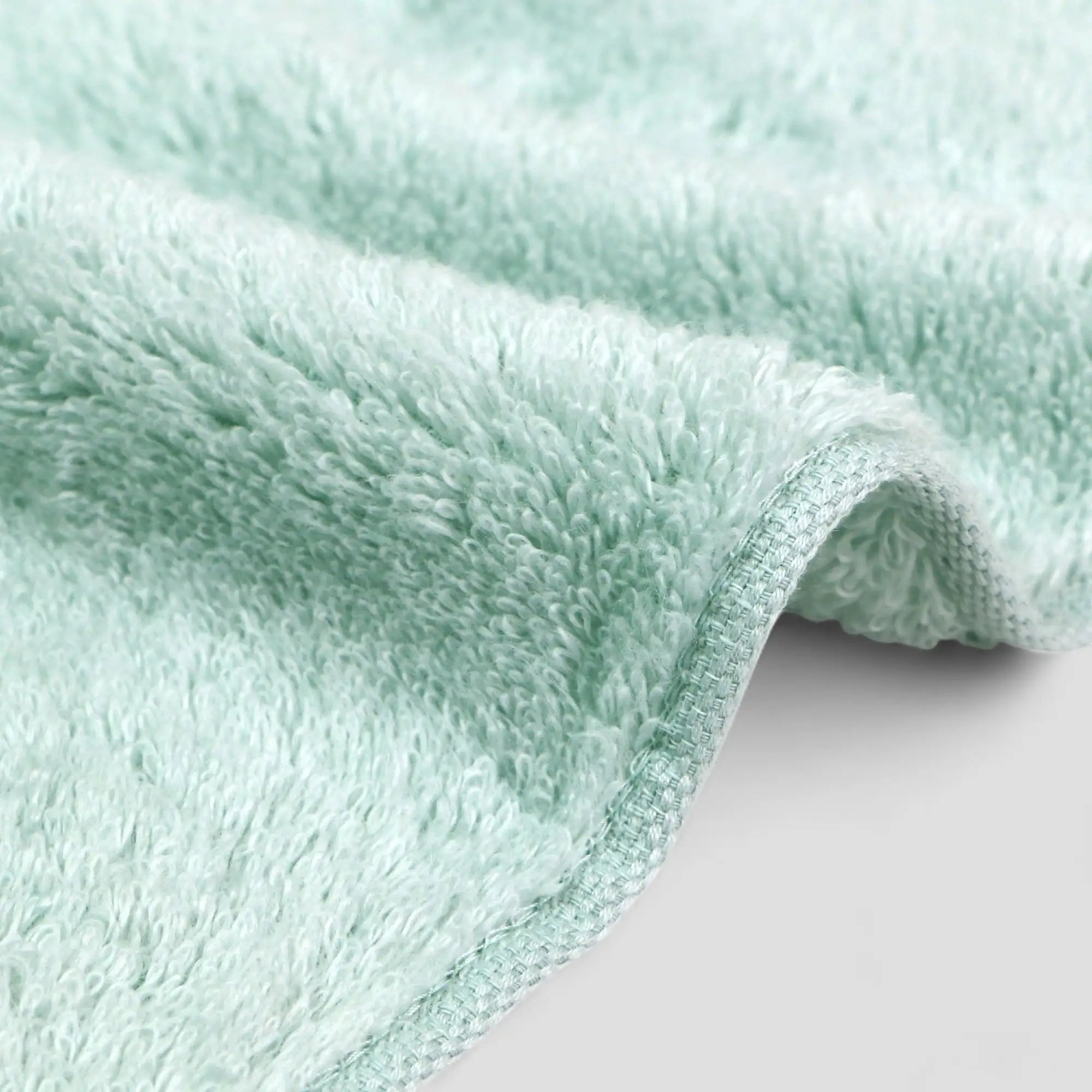 Close-up of a light blue Imabari towel textured fabric on a white background