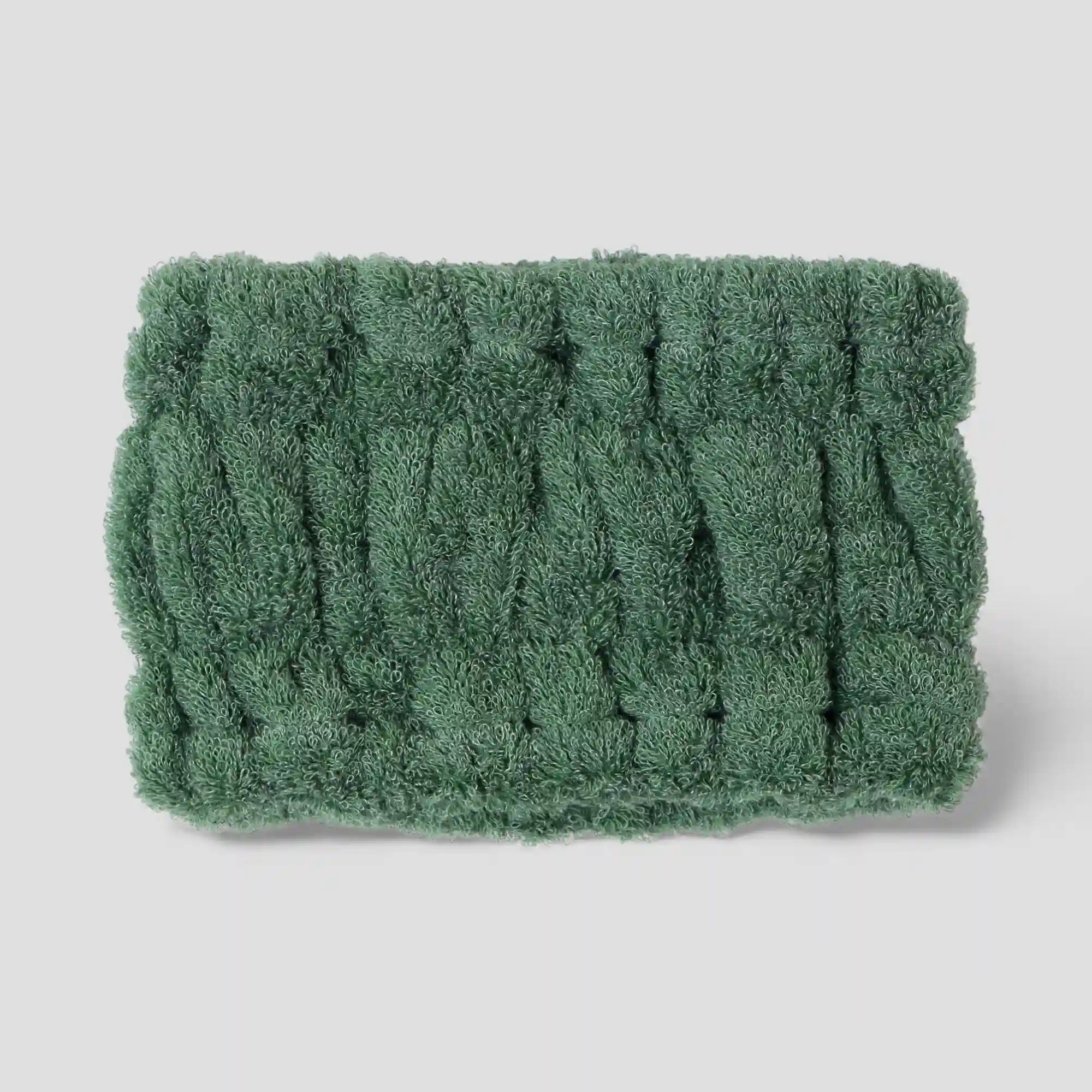 Green textured Imabari towel head band on a light gray background