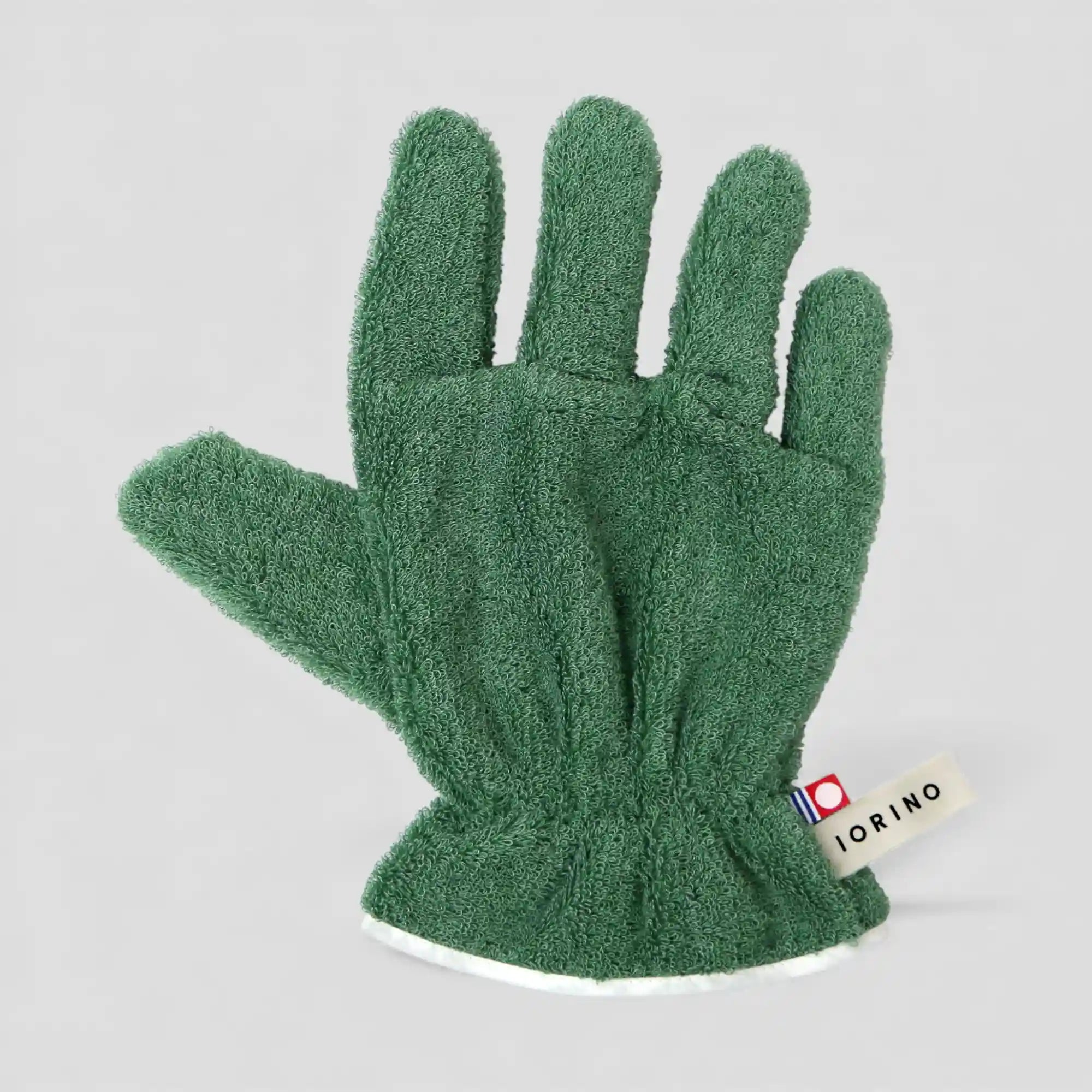 Green Imabari towel glove on a light gray background with a visible brand label.