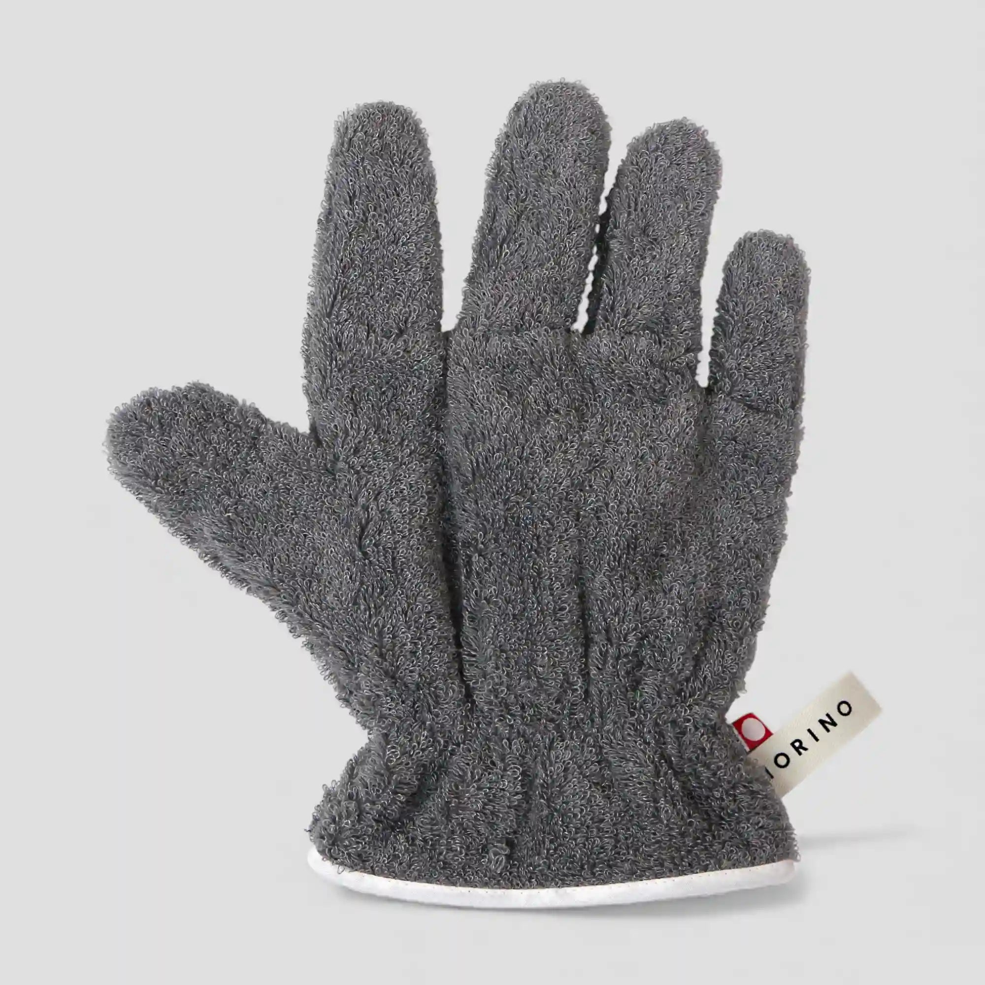 Gray Imabari towel glove with a brand label on a light gray background
