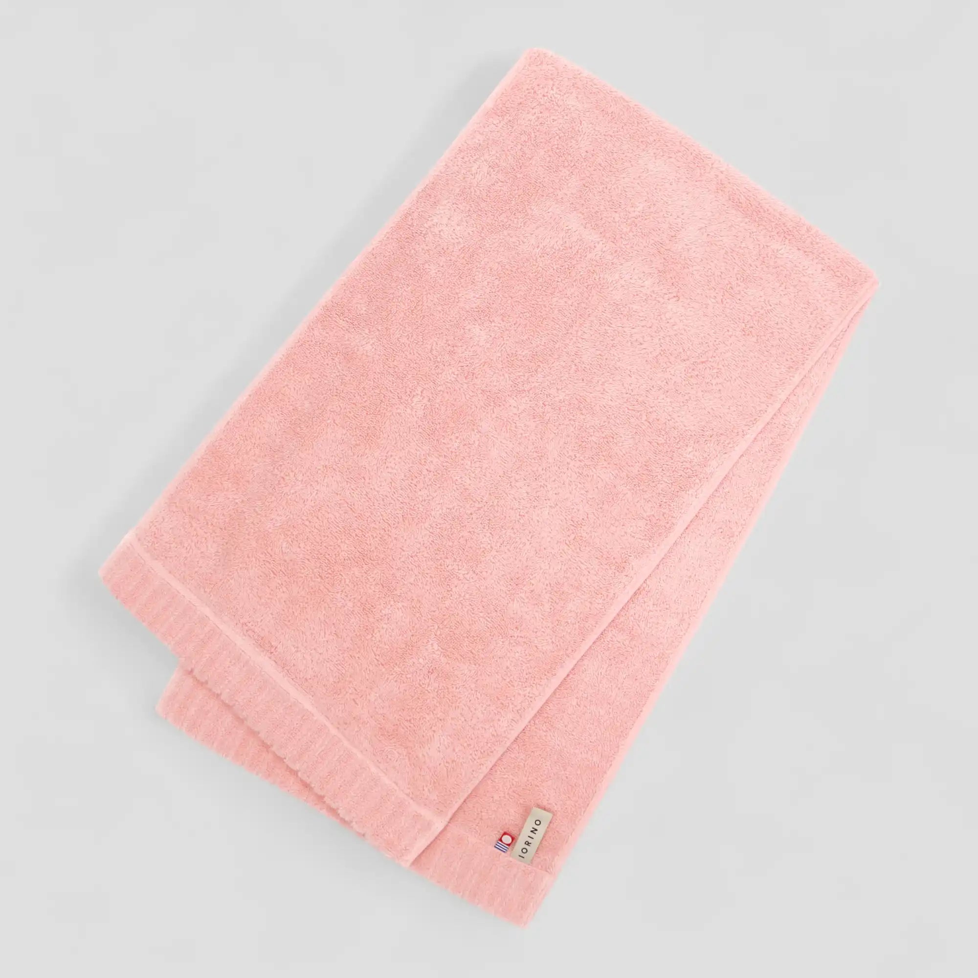 Pink Imabari towel on a gray background